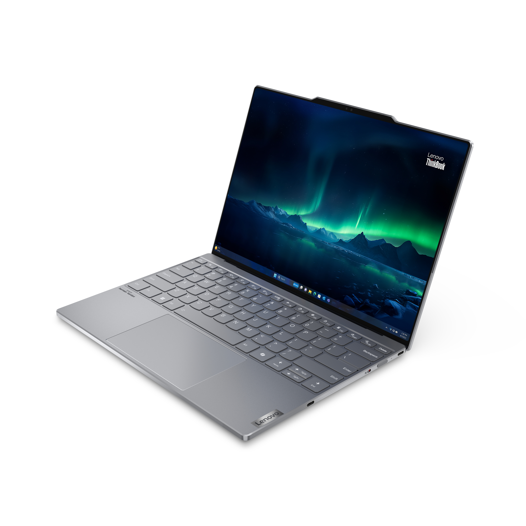Un laptop argentato è aperto, mostra uno schermo con un'immagine dell'aurora boreale verde. Si trova su una superficie bianca.