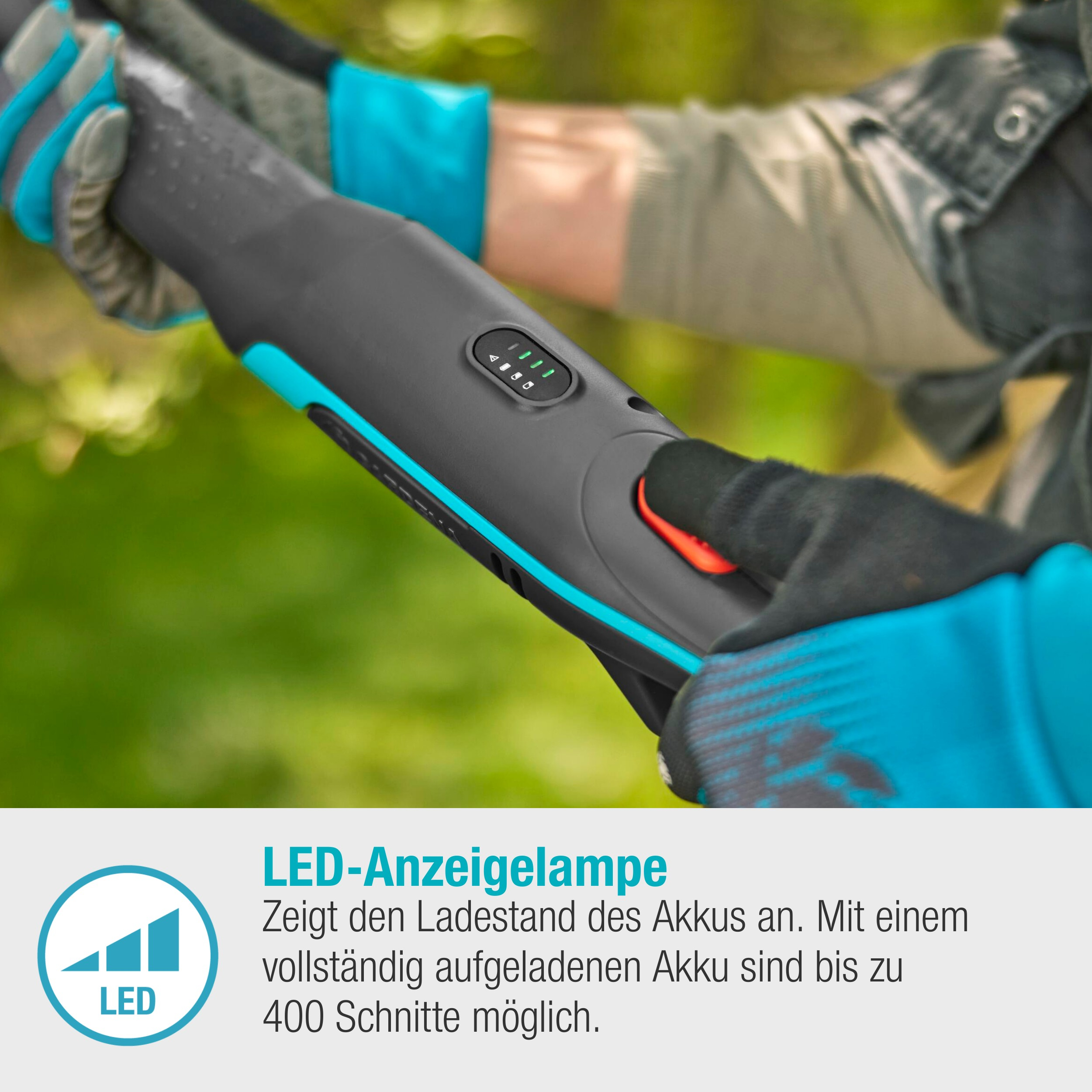 Hände, die ein Gartengerät halten, zeigen LED-Anzeigeleuchten und einen roten Knopf.