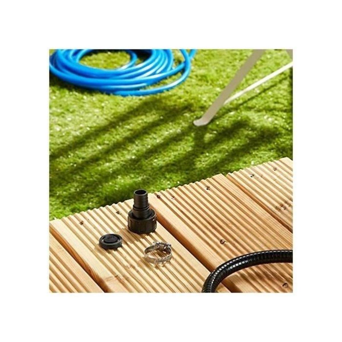 Ein Holzdeck mit einigen schwarzen und silbernen Accessoires darauf. Grüner Gras Hintergrund.