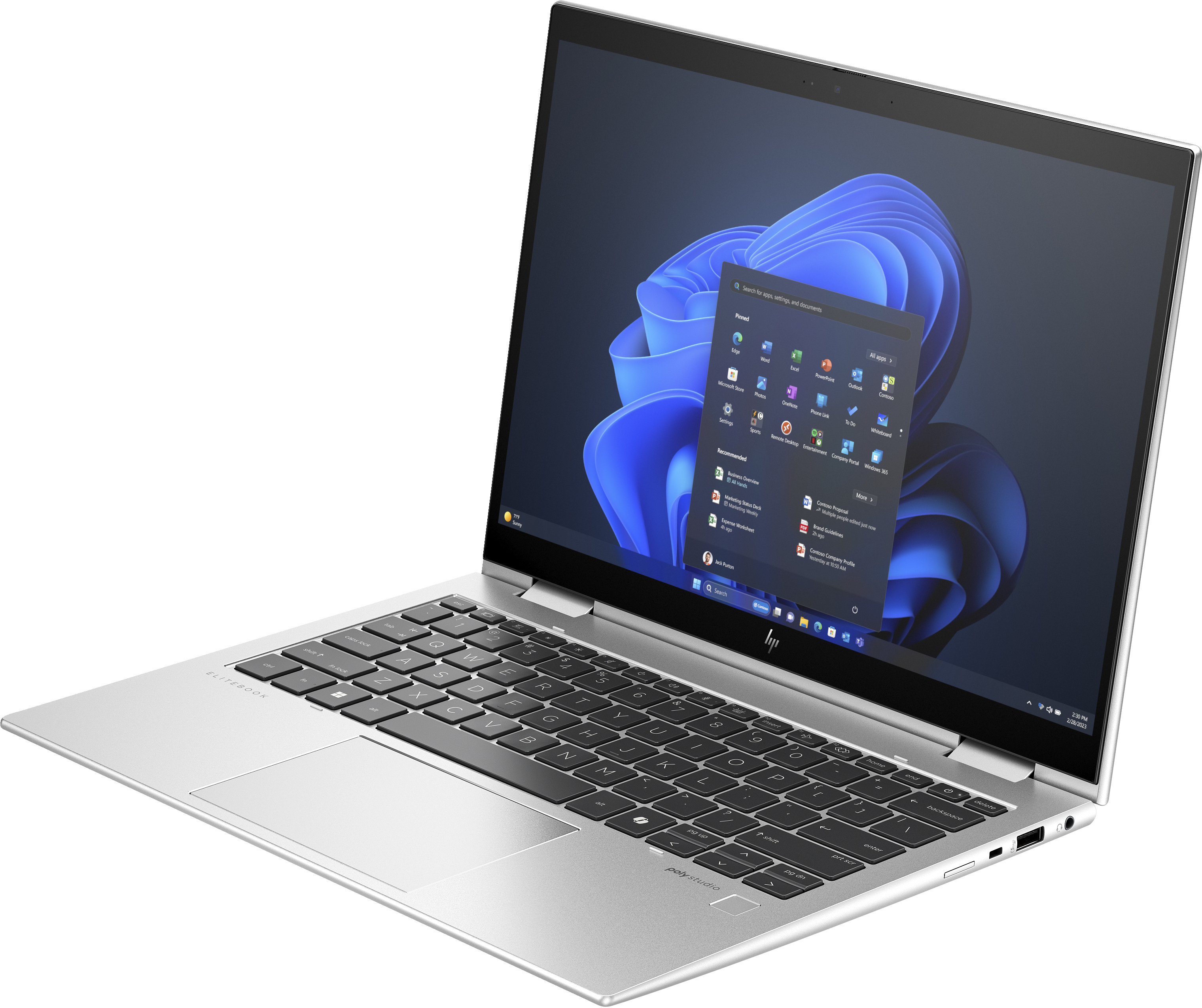 Laptop argentato aperto, mostra Windows 11 con app. La tastiera è visibile.