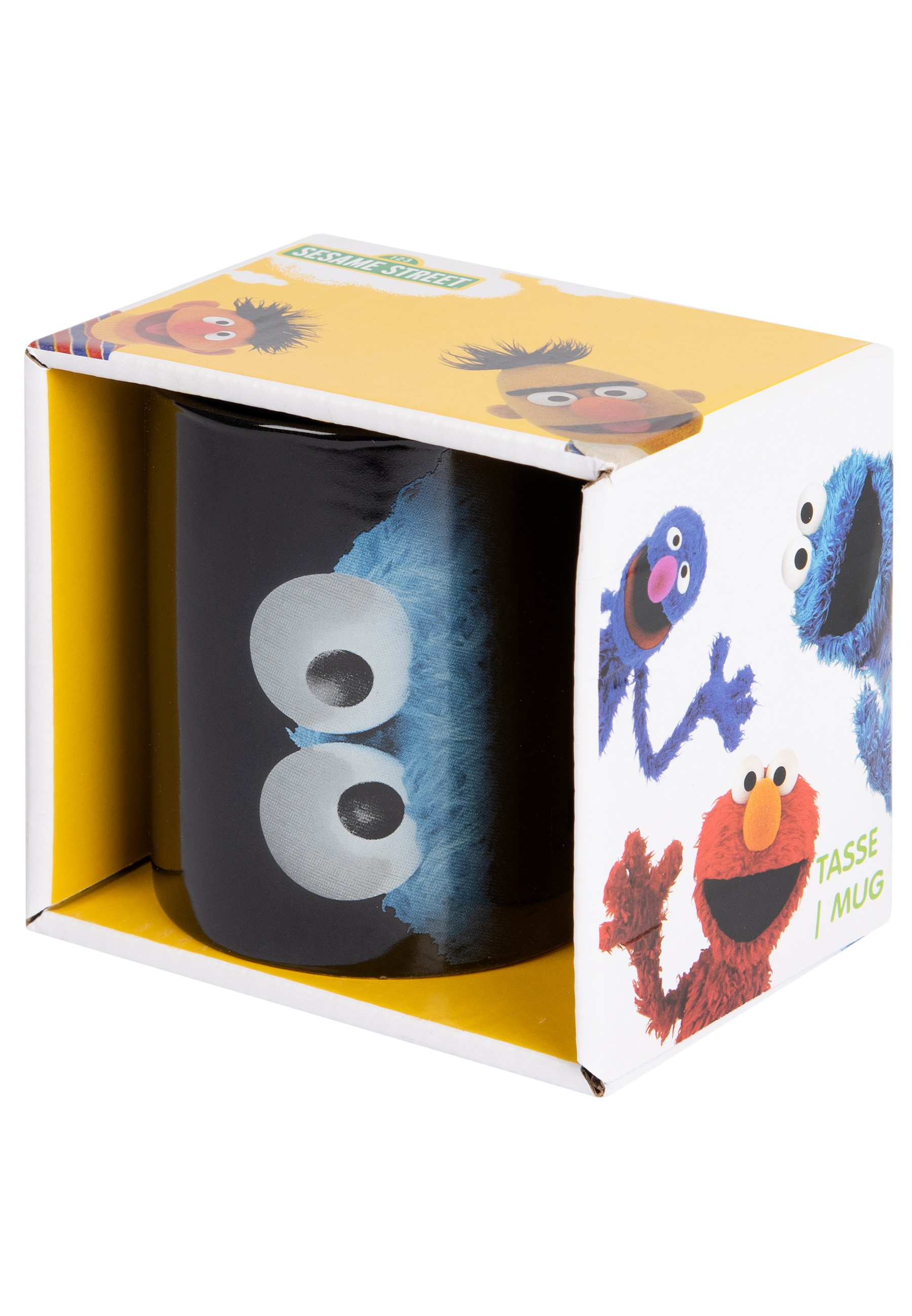 Krümelmonster-Tasse in einer Box. Schwarze Tasse mit Krümelmonsters Augen und einem blauen Mund.