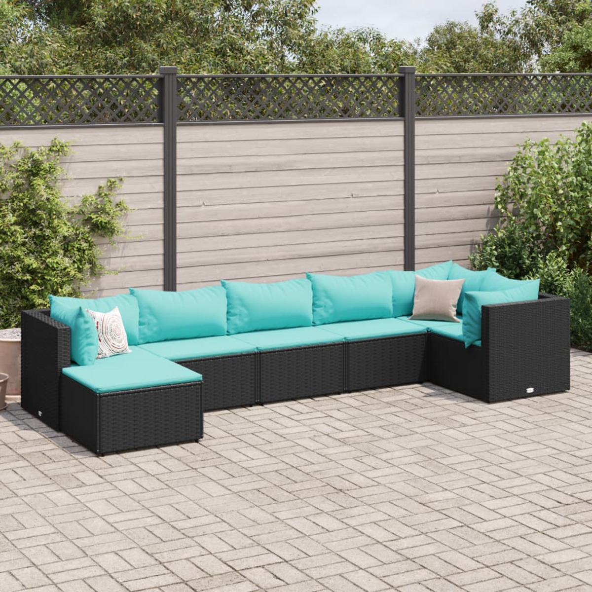 Divano componibile nero da esterno con cuscini turchese su patio pavimentato.