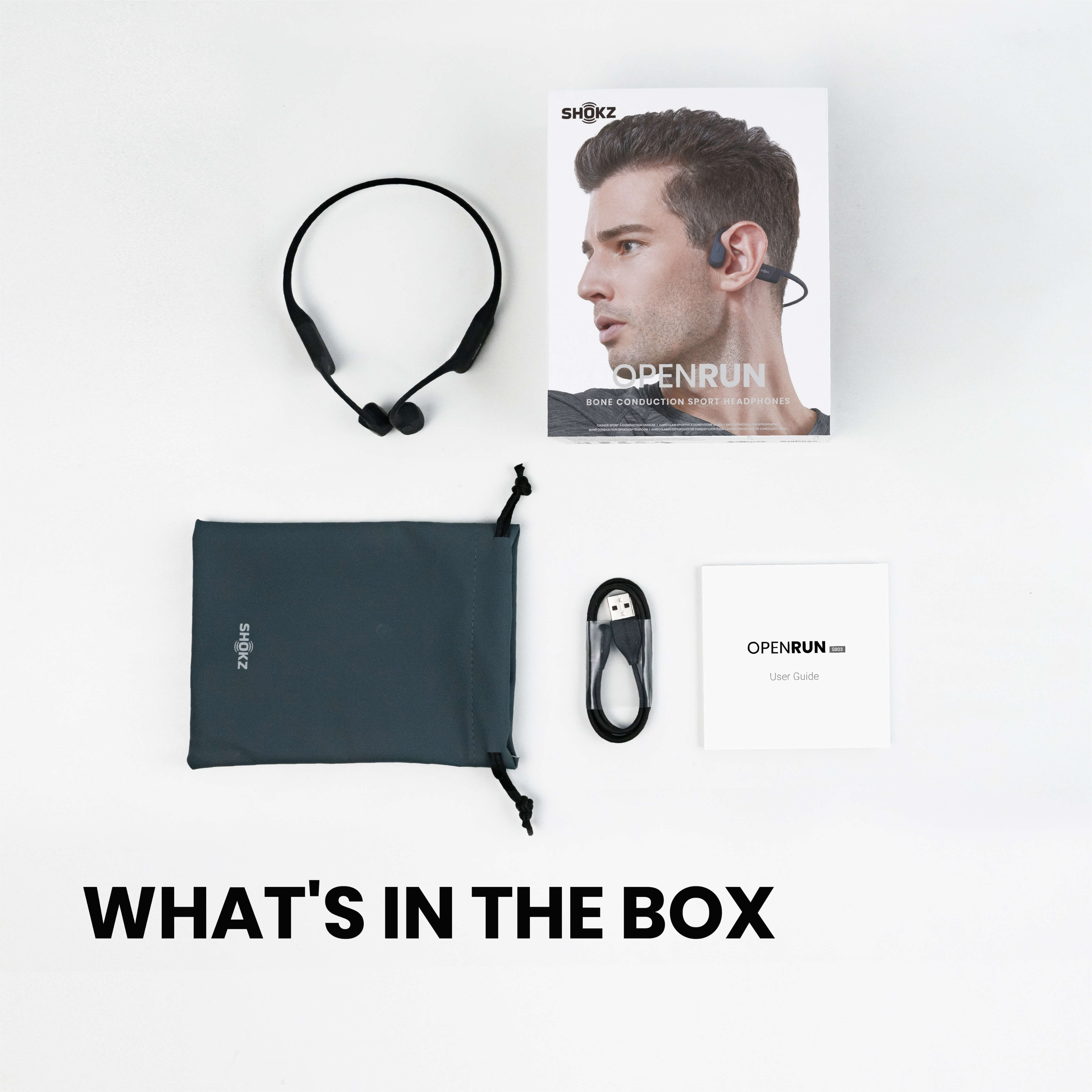 Eine Box mit Knochenschallkopfhörern und Zubehör. Der Text lautet 'WHAT'S IN THE BOX' unten.