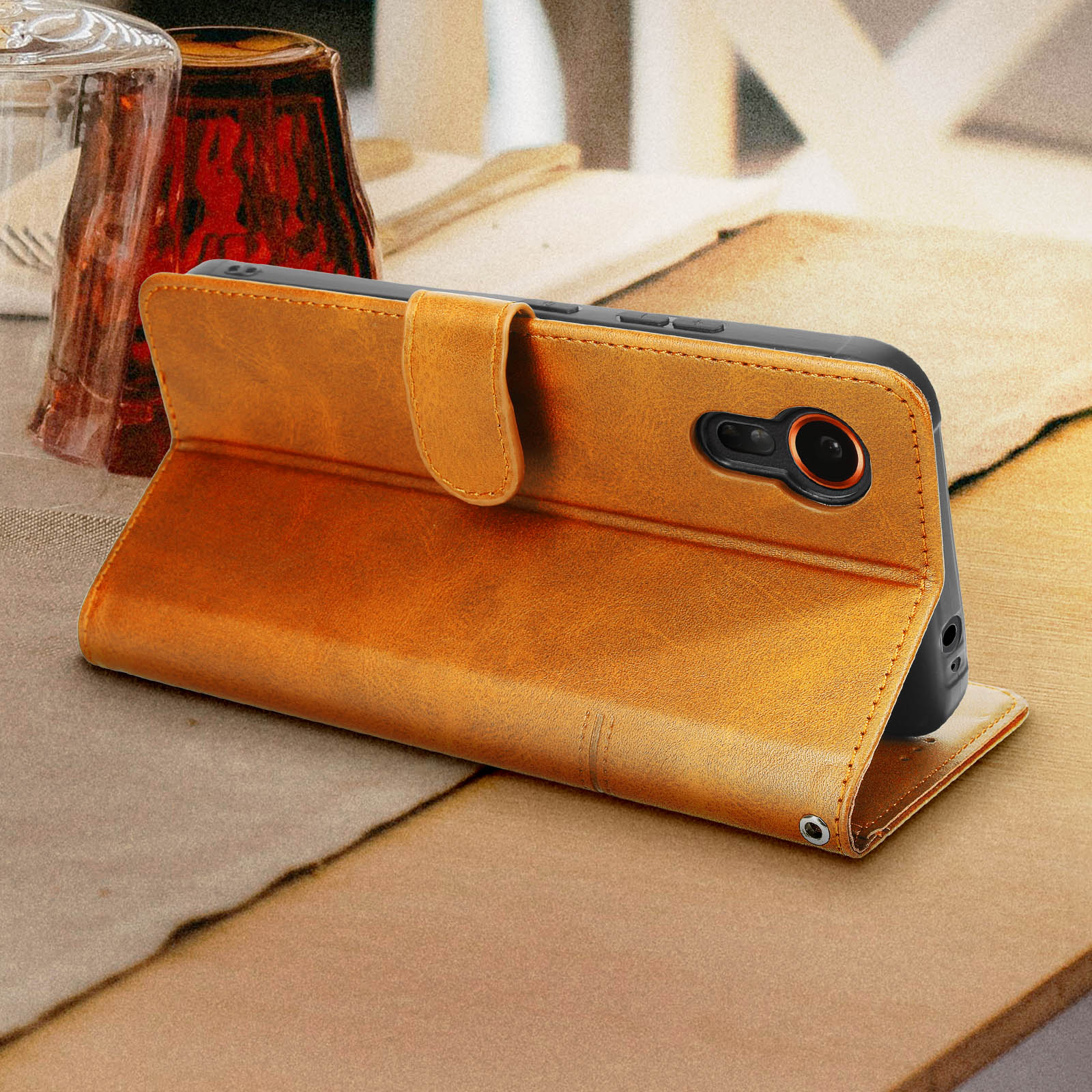 Eine braune Leder-Handyhülle geöffnet, zeigt ein Telefon mit Kameraobjektiv.