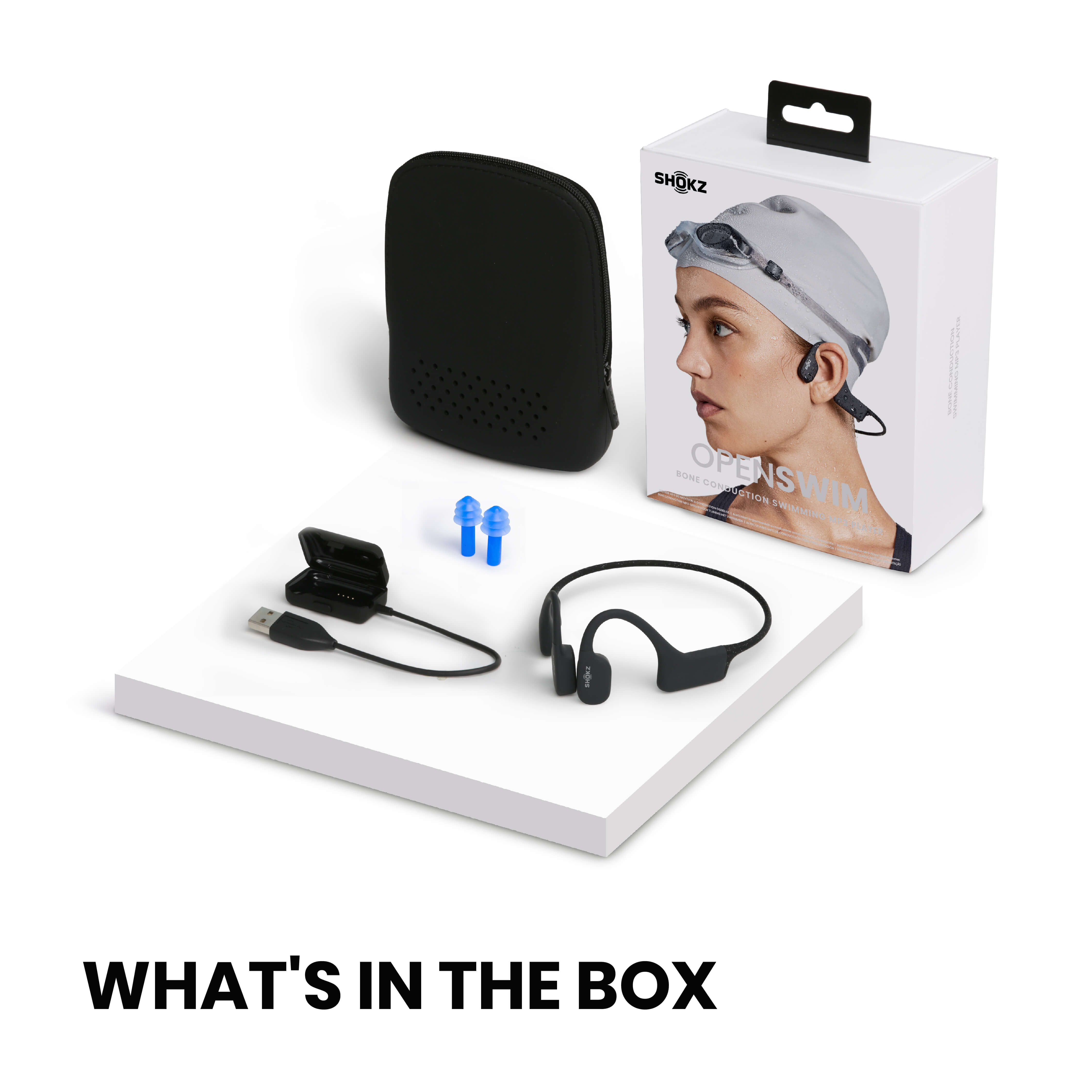 Pudełko ze słuchawkami do pływania, akcesoriami i kablem do ładowania. W zestawie niebieskie zatyczki.