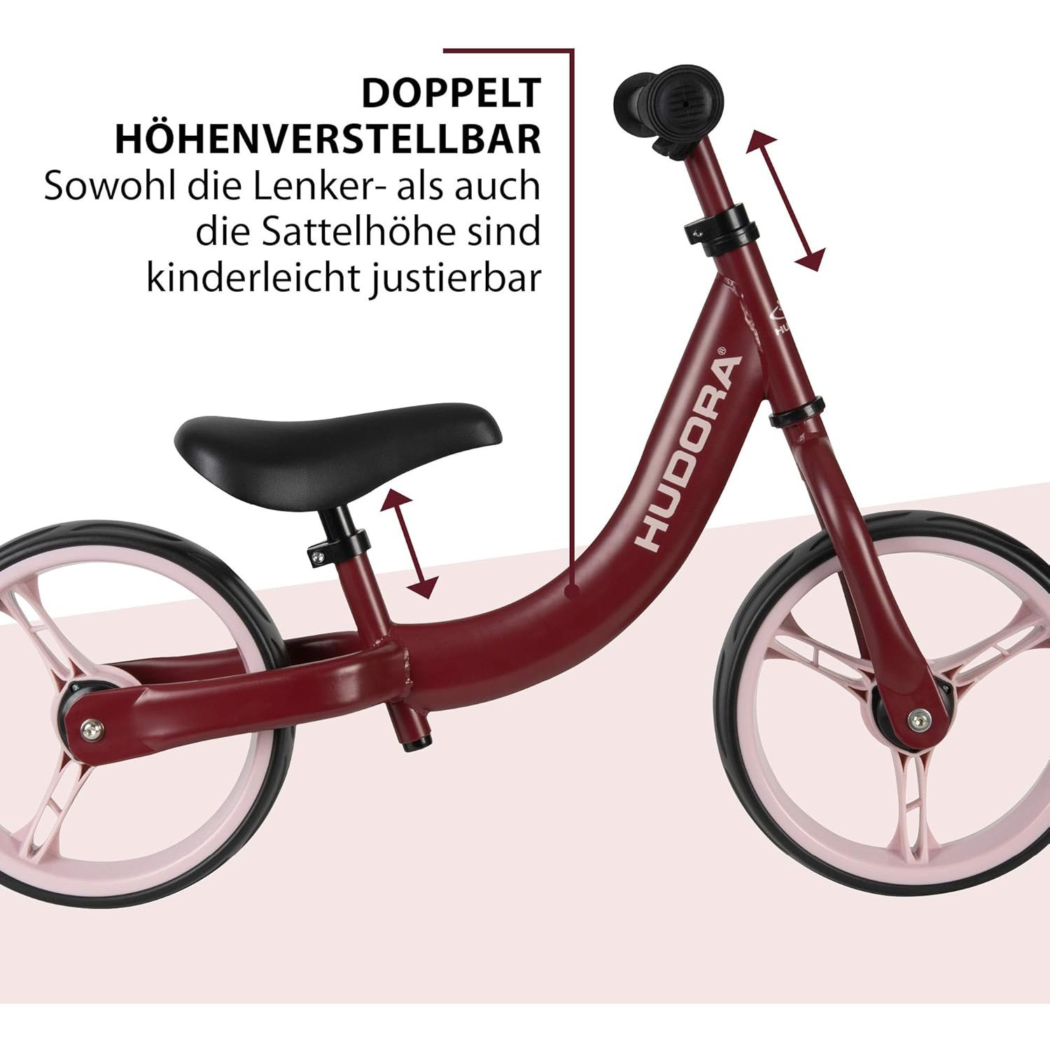 Rotes Laufrad mit schwarzem Sitz und Lenker. Es hat rosa Räder und Pfeile.