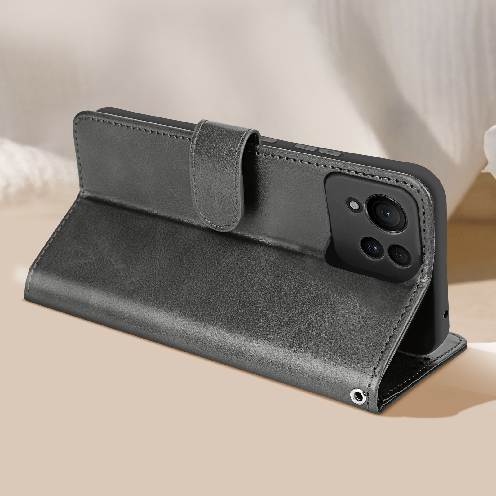 Graue Leder-Handyhülle, offen, zeigt ein Telefon und einen Magnetverschluss, auf beiger Oberfläche.