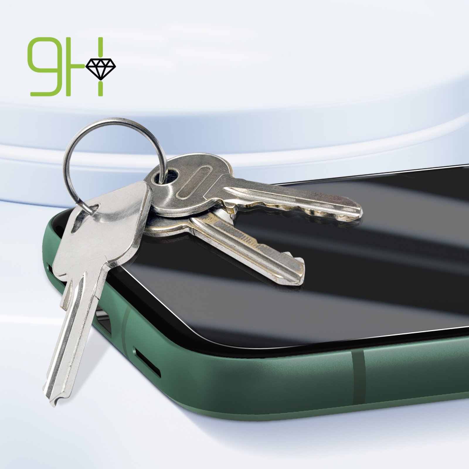 Chiavi appoggiate su uno schermo verde del telefono. Il telefono è su una superficie bianca.