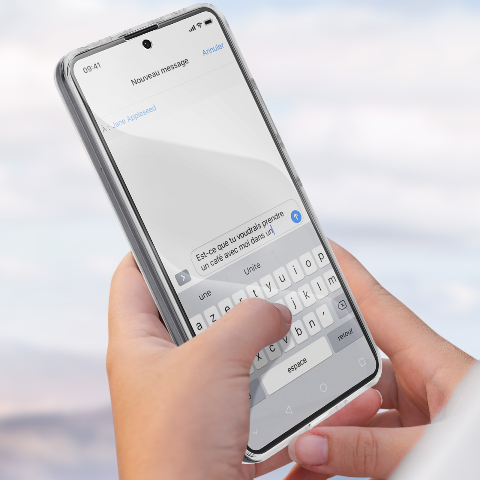 Una persona che tiene in mano un telefono con un messaggio sullo schermo e una tastiera.