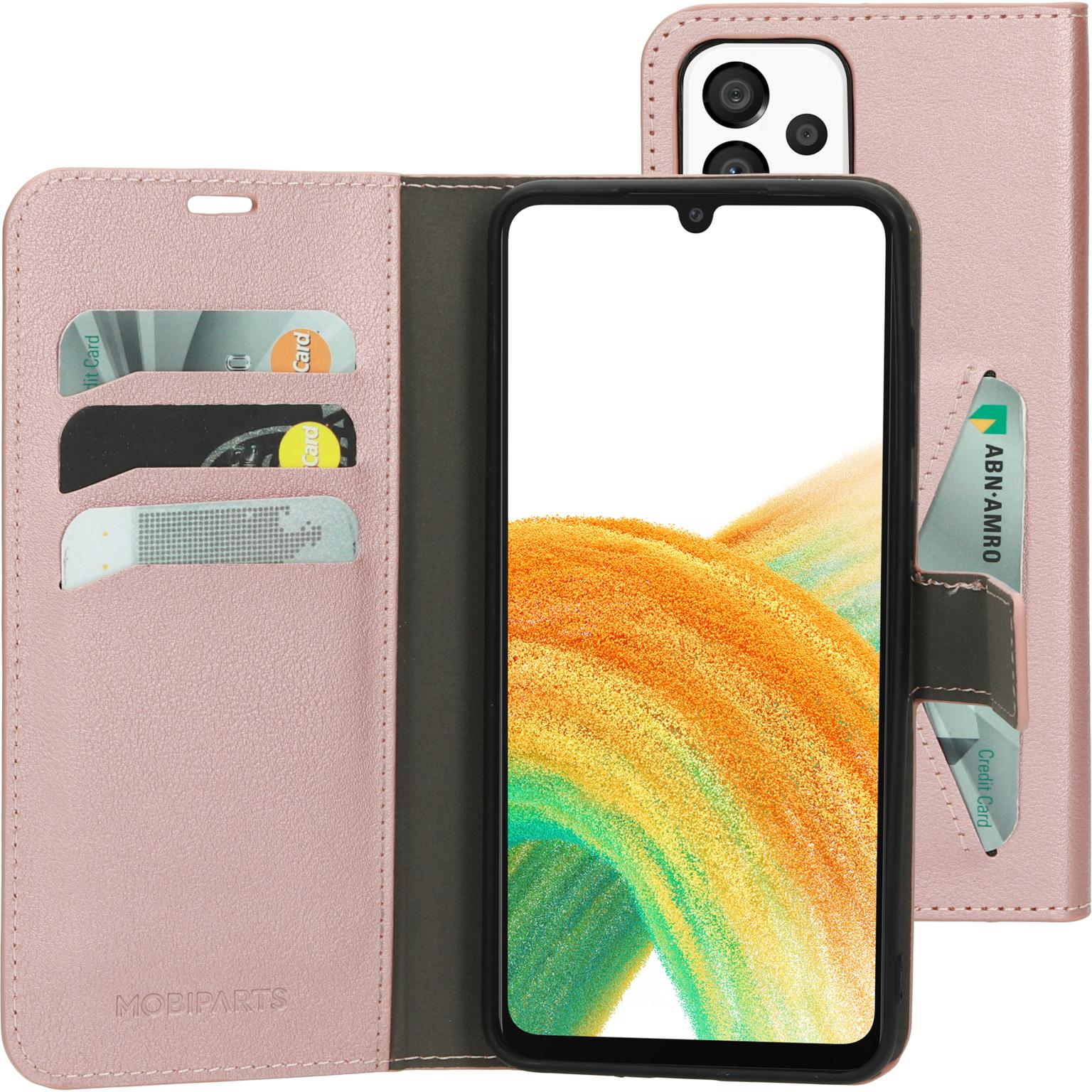 Roze telefoonhoes, open, met telefoon en kaarten. ABN-AMRO kaart zichtbaar.