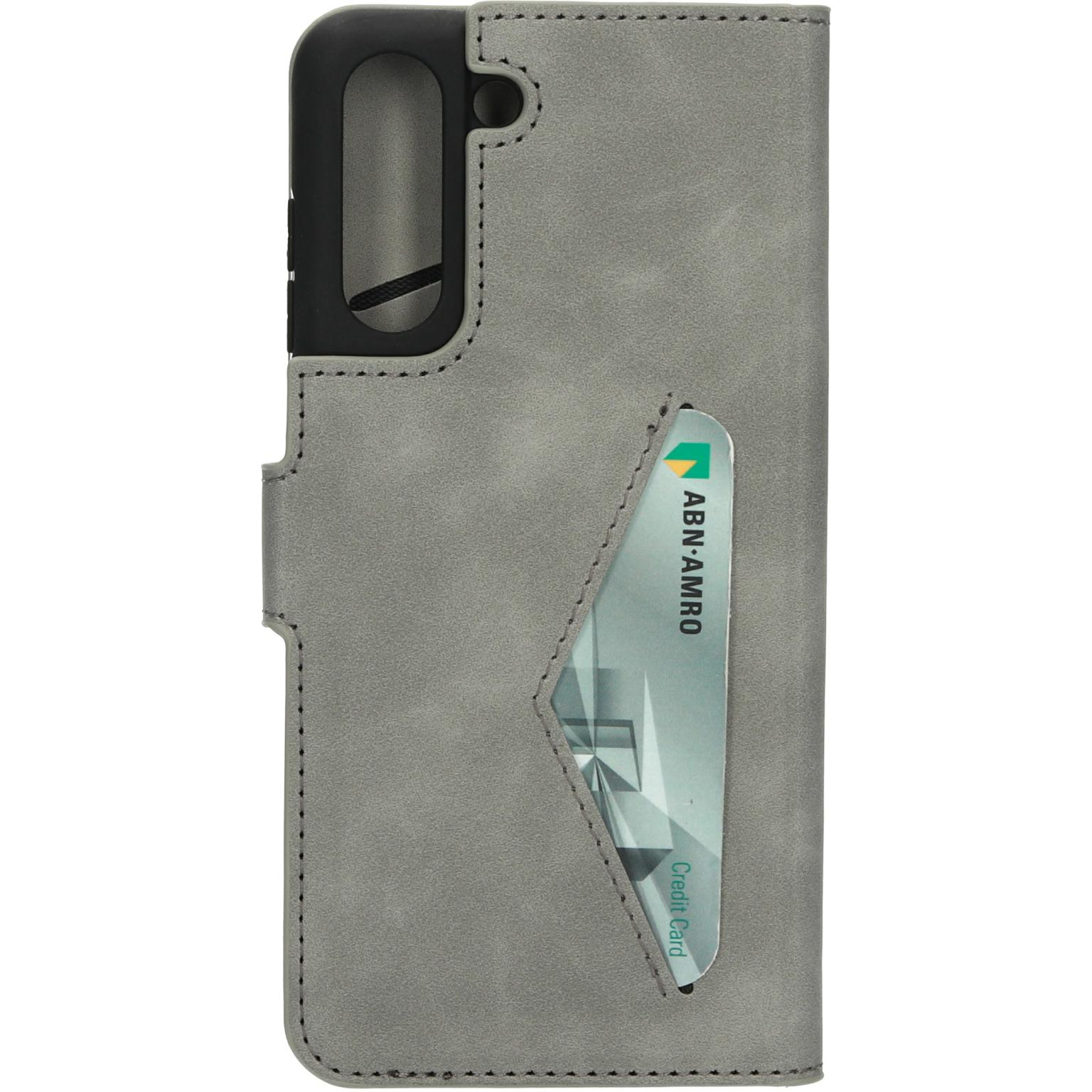 A grey phone case with a credit card in the slot. Black camera cutout. Stitched edges.
