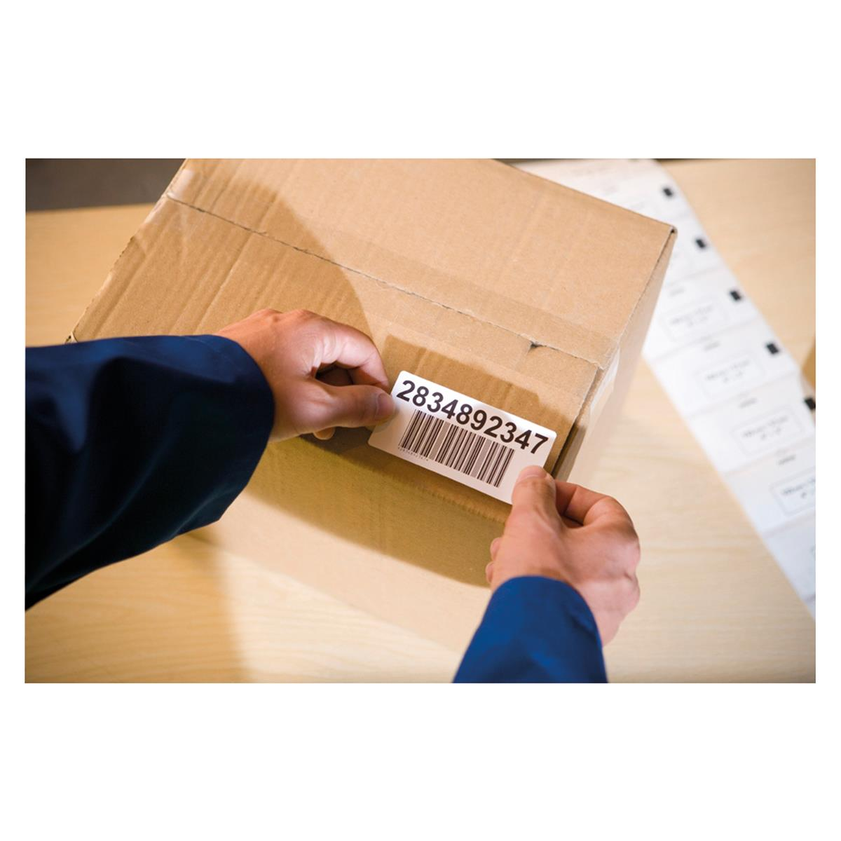 Persona che applica un'etichetta con codice a barre e numero 2834892347 su un pacco.