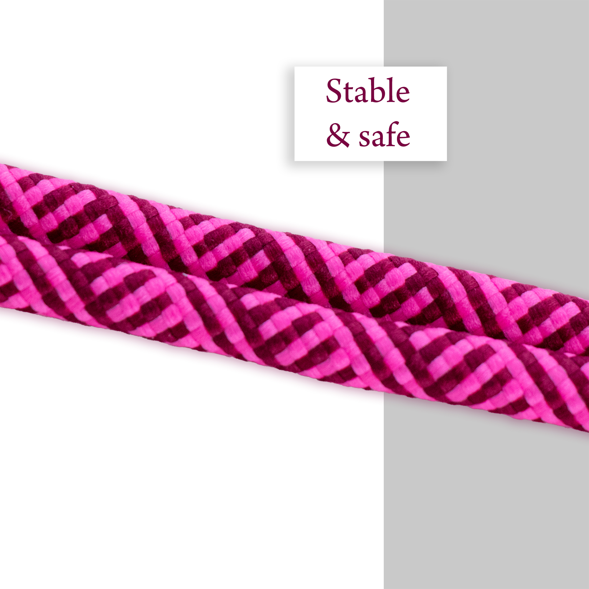 Nahaufnahme eines rosa geflochtenen Lanyard-Seils. Weißer und grauer Hintergrund.