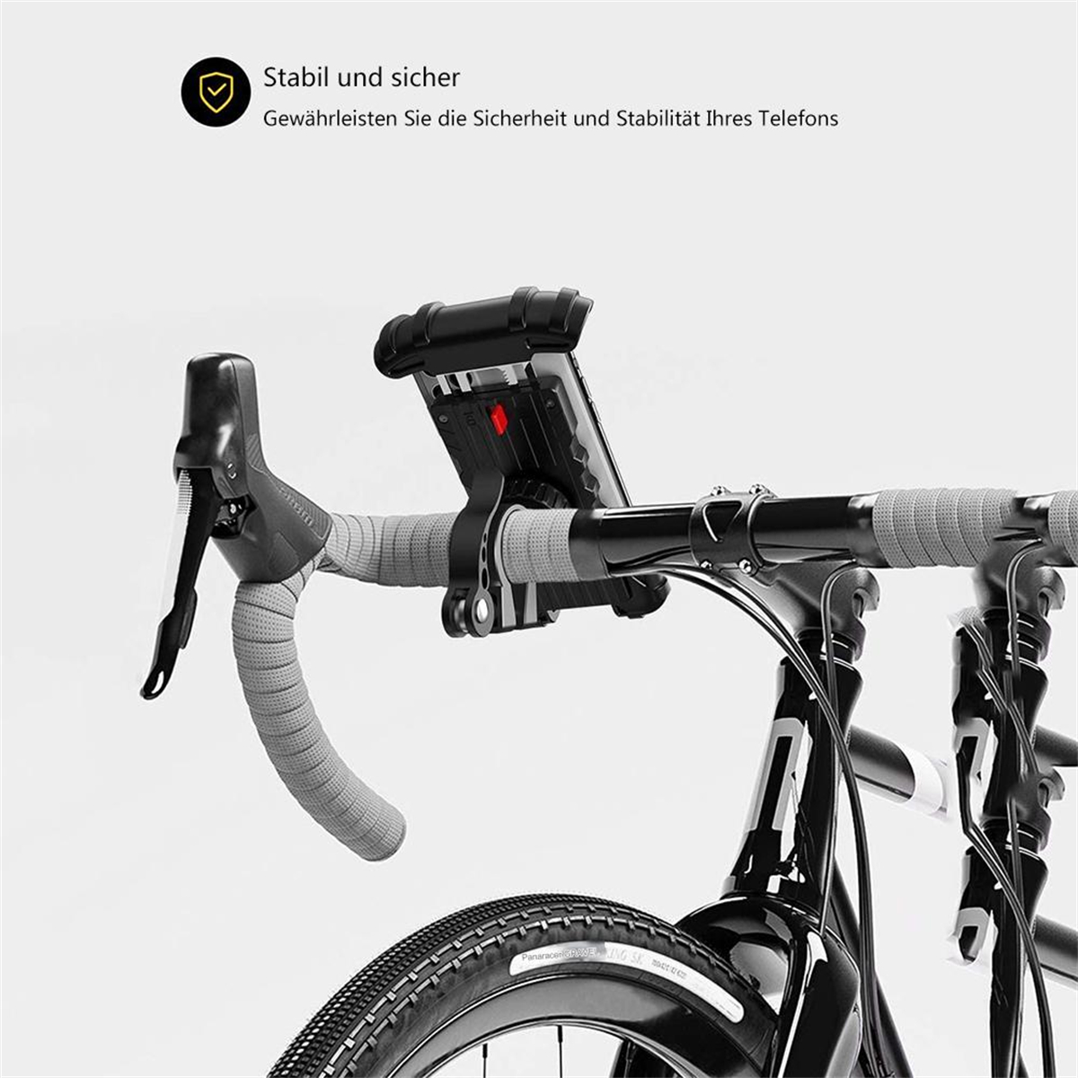 Ein Fahrradlenker mit einer daran befestigten Telefonhalterung, und der Text lautet: 