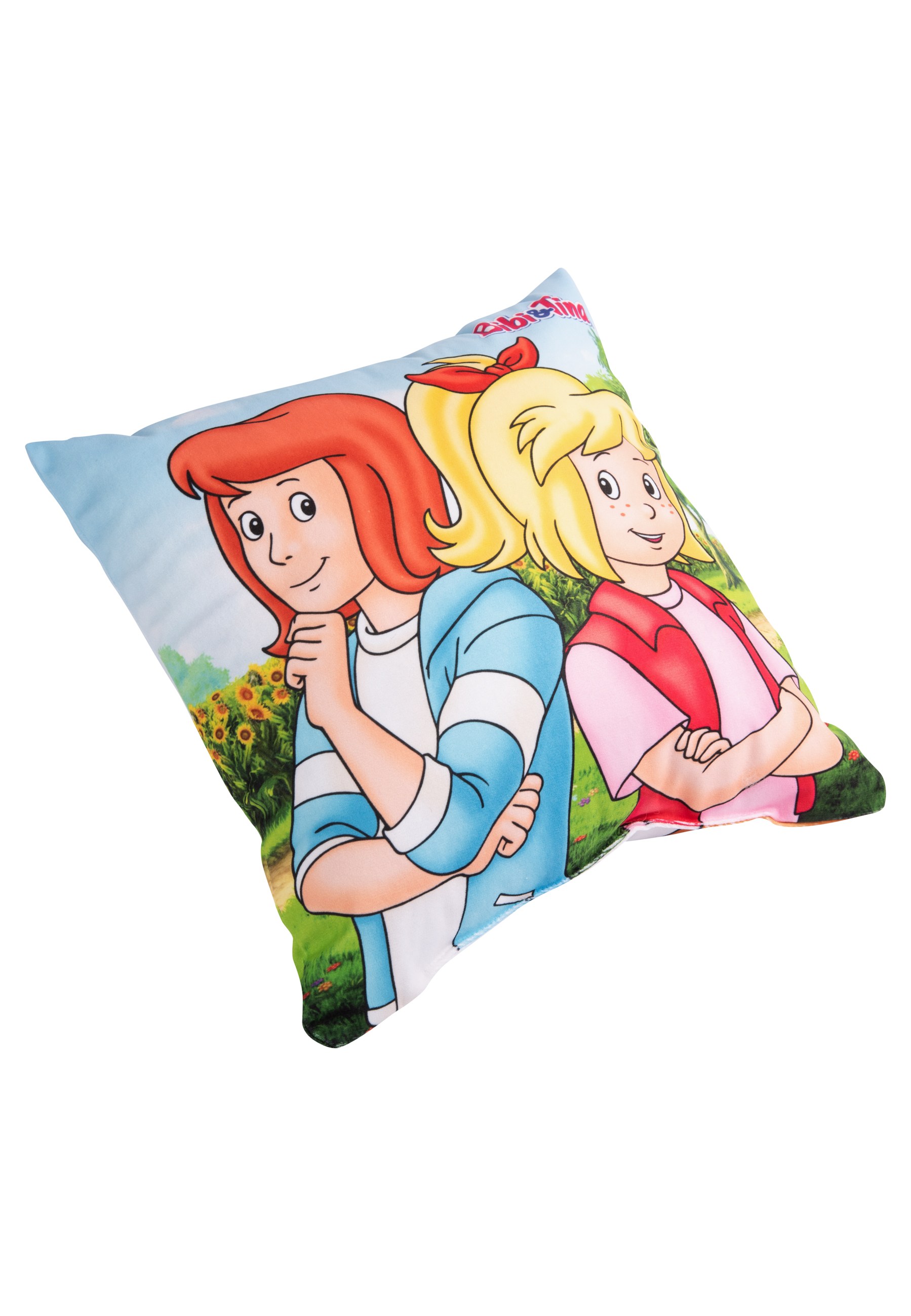 Kissen mit Cartoon von zwei Mädchen mit roten und blonden Haaren, blauen und rosa Outfits. Grüner Hintergrund.