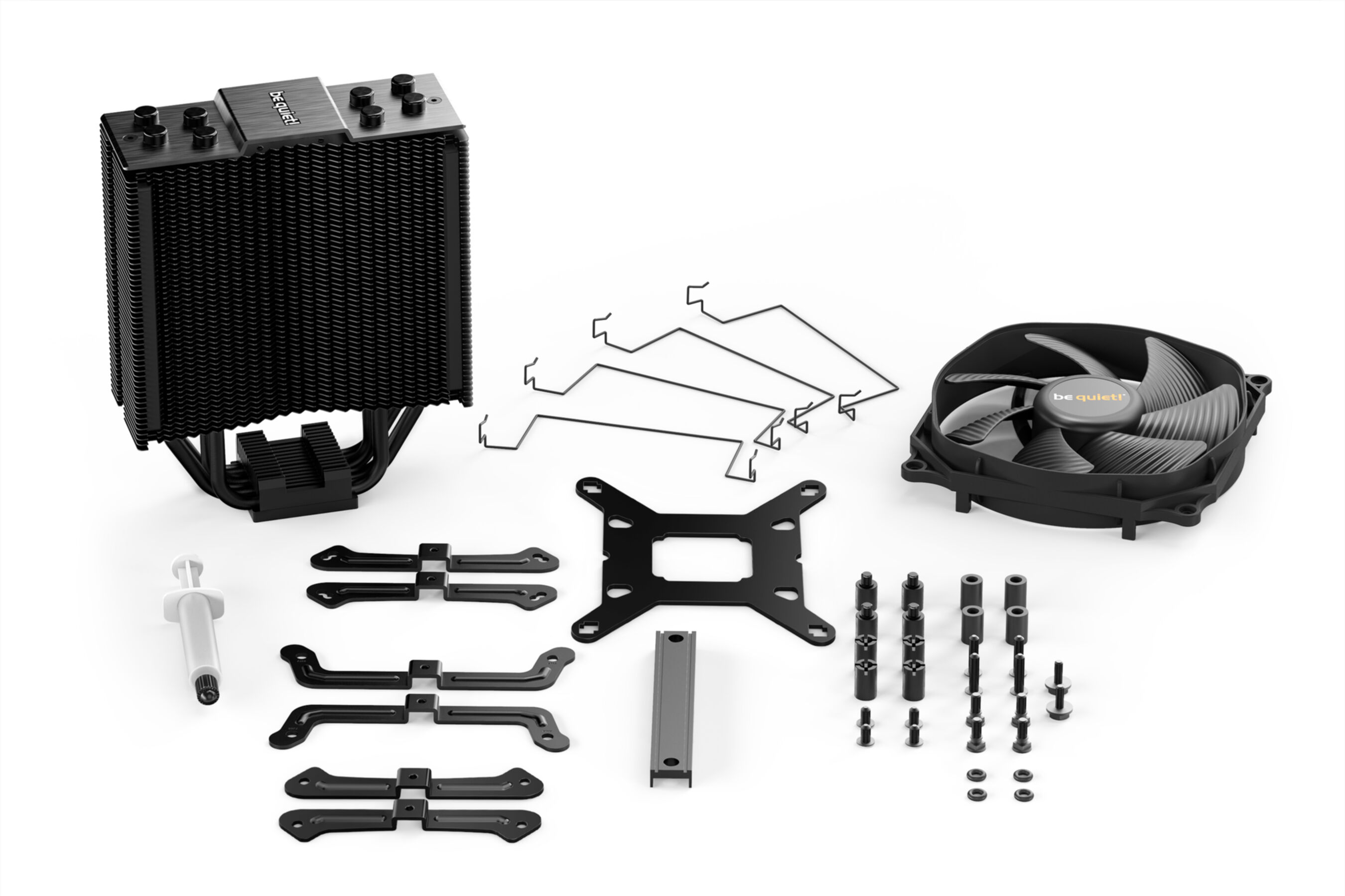 Elementy chłodzenia komputera: radiator, wentylator, wsporniki i pasta termoprzewodząca. Wszystkie czarne.
