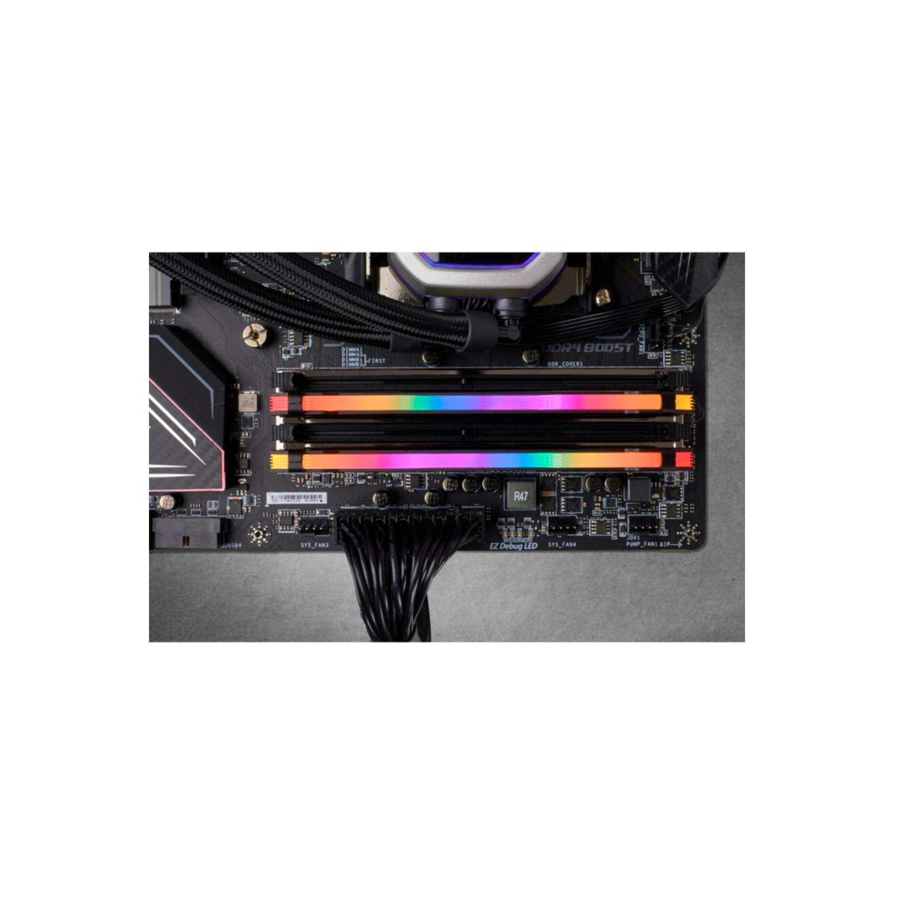 Nahaufnahme eines Motherboards mit farbenfrohen RAM-Riegeln, Kabeln und Kühlungskomponenten.