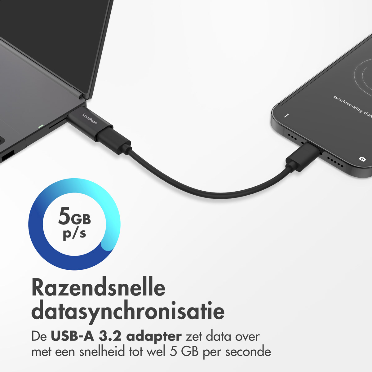 A black USB-A adapter is connected to a laptop and a phone.