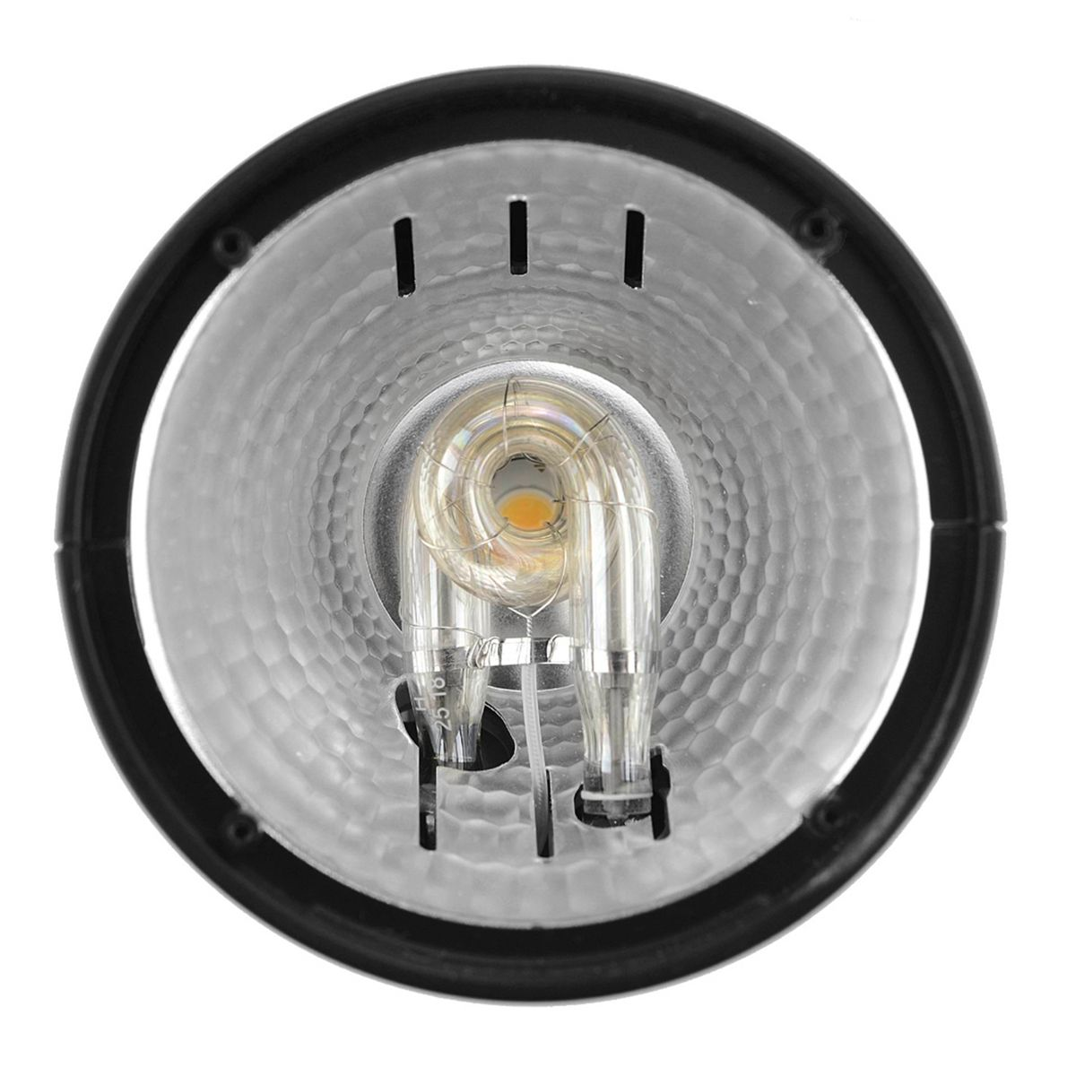 Nahaufnahme einer Halogenlampe mit Reflektor, die die Glühbirne und die inneren Komponenten zeigt.