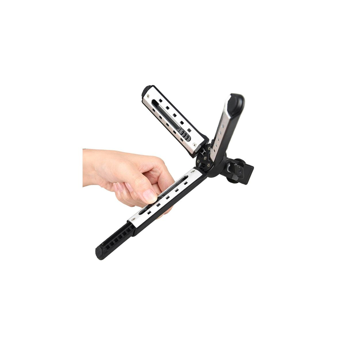 Una mano che tiene un accessorio per fotocamera nero e argento. L'accessorio è aperto e angolato.