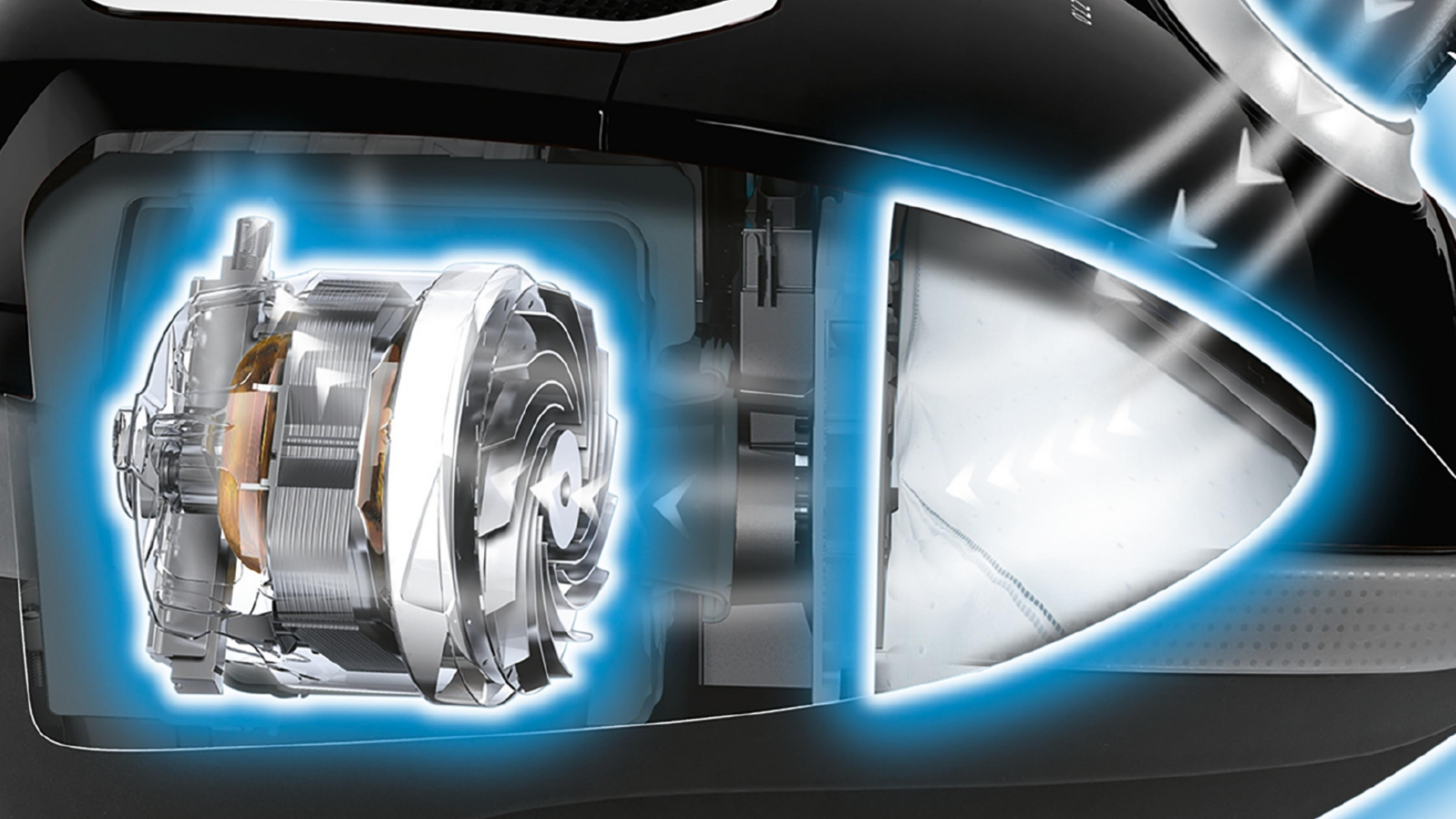 Silnik i elementy filtra odkurzacza, ze zaznaczonymi ścieżkami przepływu.