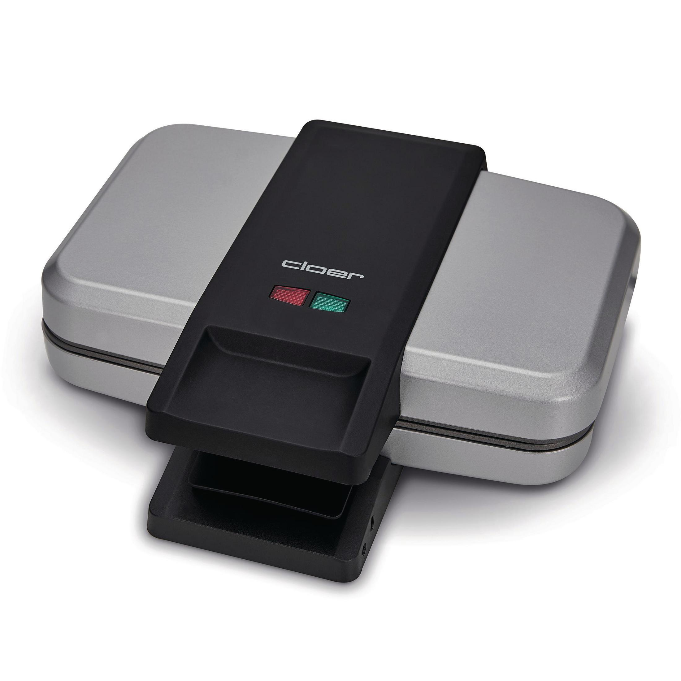 Srebrna gofrownica z czarnym uchwytem i czerwonymi i zielonymi lampkami kontrolnymi. Zamknięty, widok z góry.