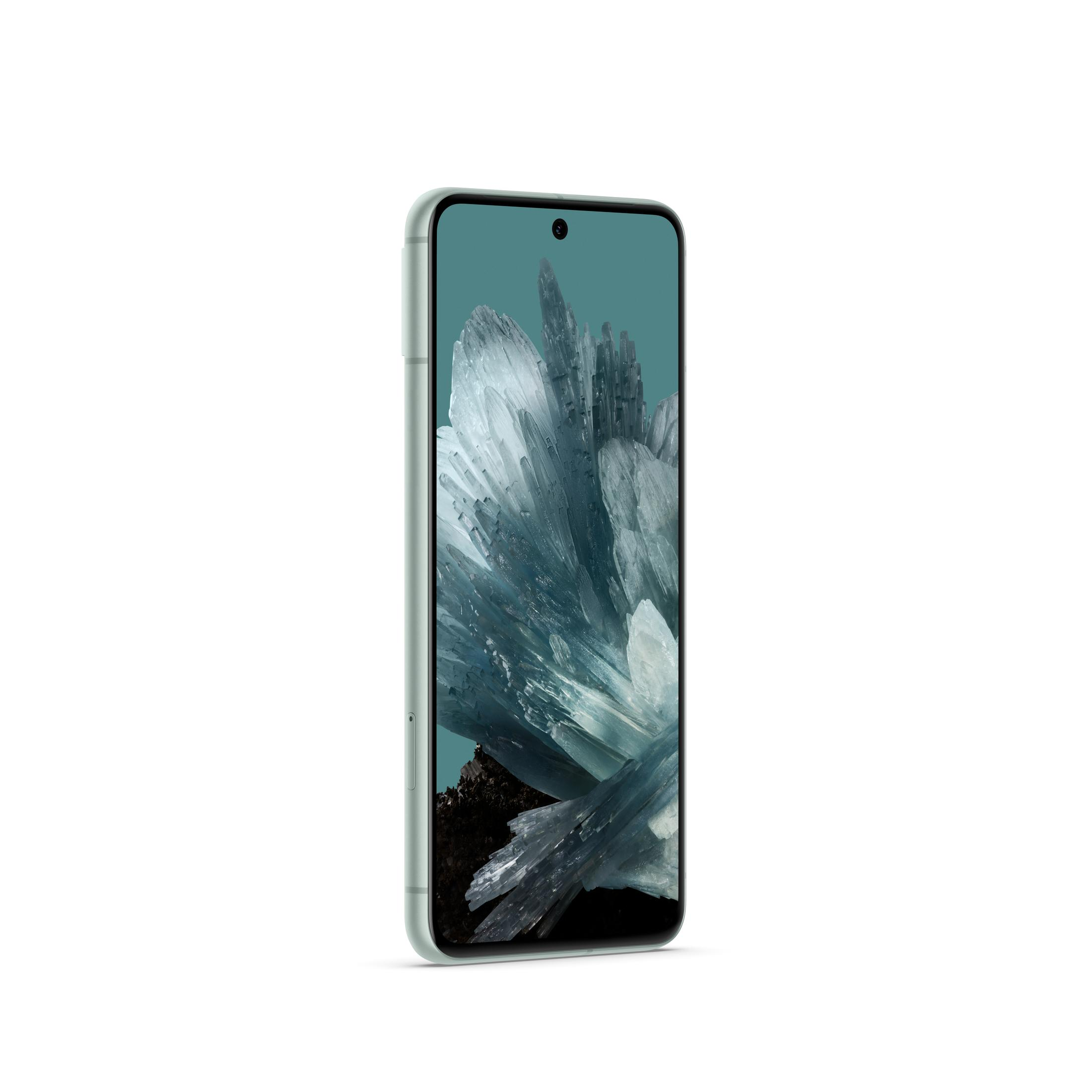 Ein mintgrünes Smartphone mit einem Bildschirm, der ein kristallartiges Bild zeigt, auf weißem Hintergrund.