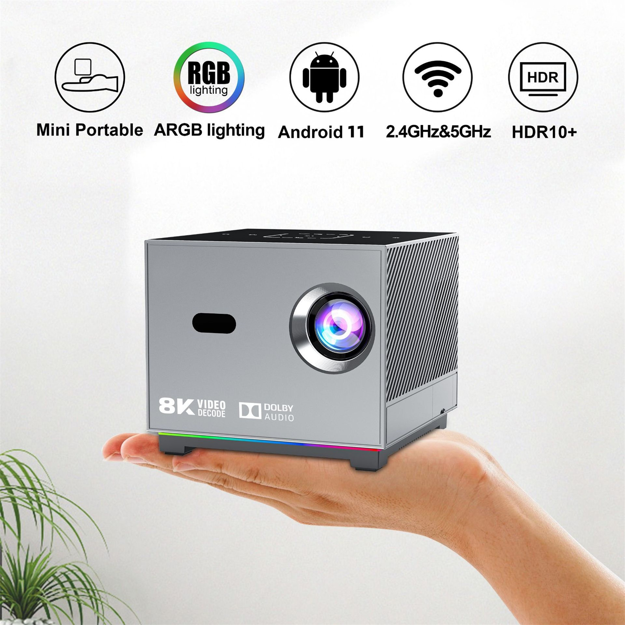 Silberner Projektor mit RGB-Beleuchtung, in der Hand gehalten. Zeigt Symbole.