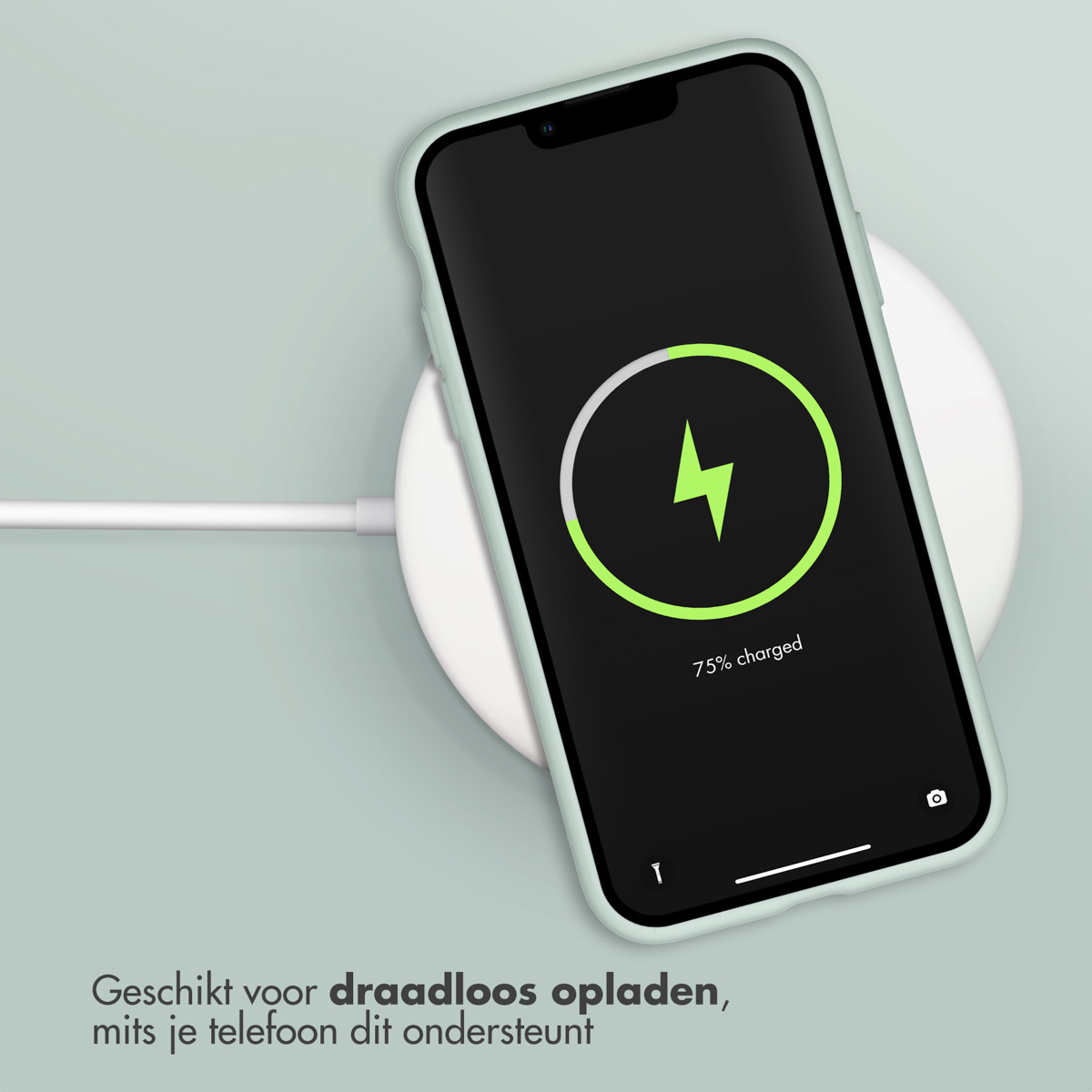 Un téléphone se charge sans fil sur un socle de chargement blanc. L'écran affiche 75 % chargé.