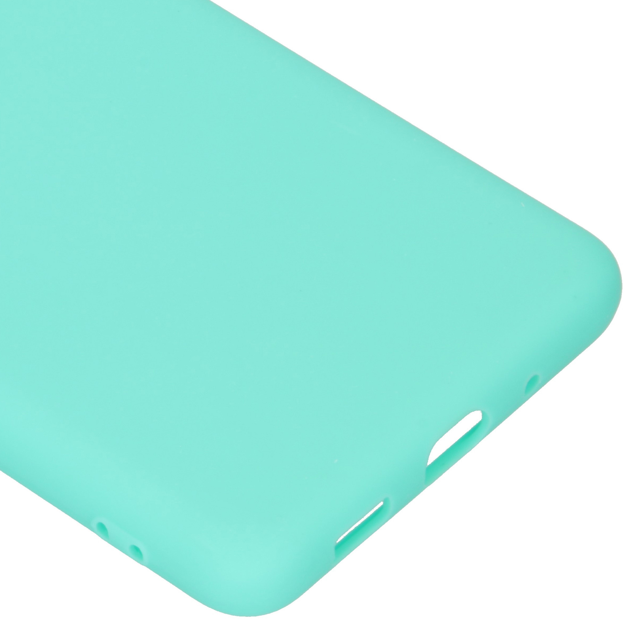 Gros plan sur une coque de téléphone vert clair, montrant le bord avec des ouvertures pour les ports et les boutons.
