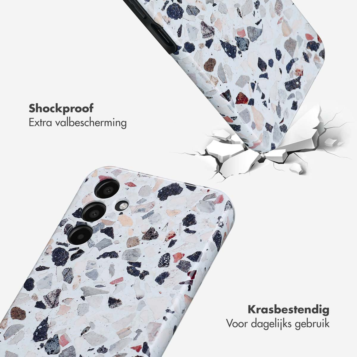 Twee telefoonhoesjes, één valt, barst de grond. Hoesjes hebben een wit, terrazzo-achtig ontwerp.