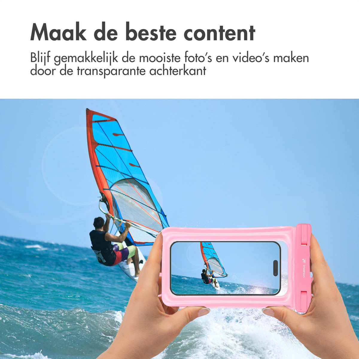 A person windsurfing is seen through a pink phone case. The case has a phone inside, and is held by two hands.