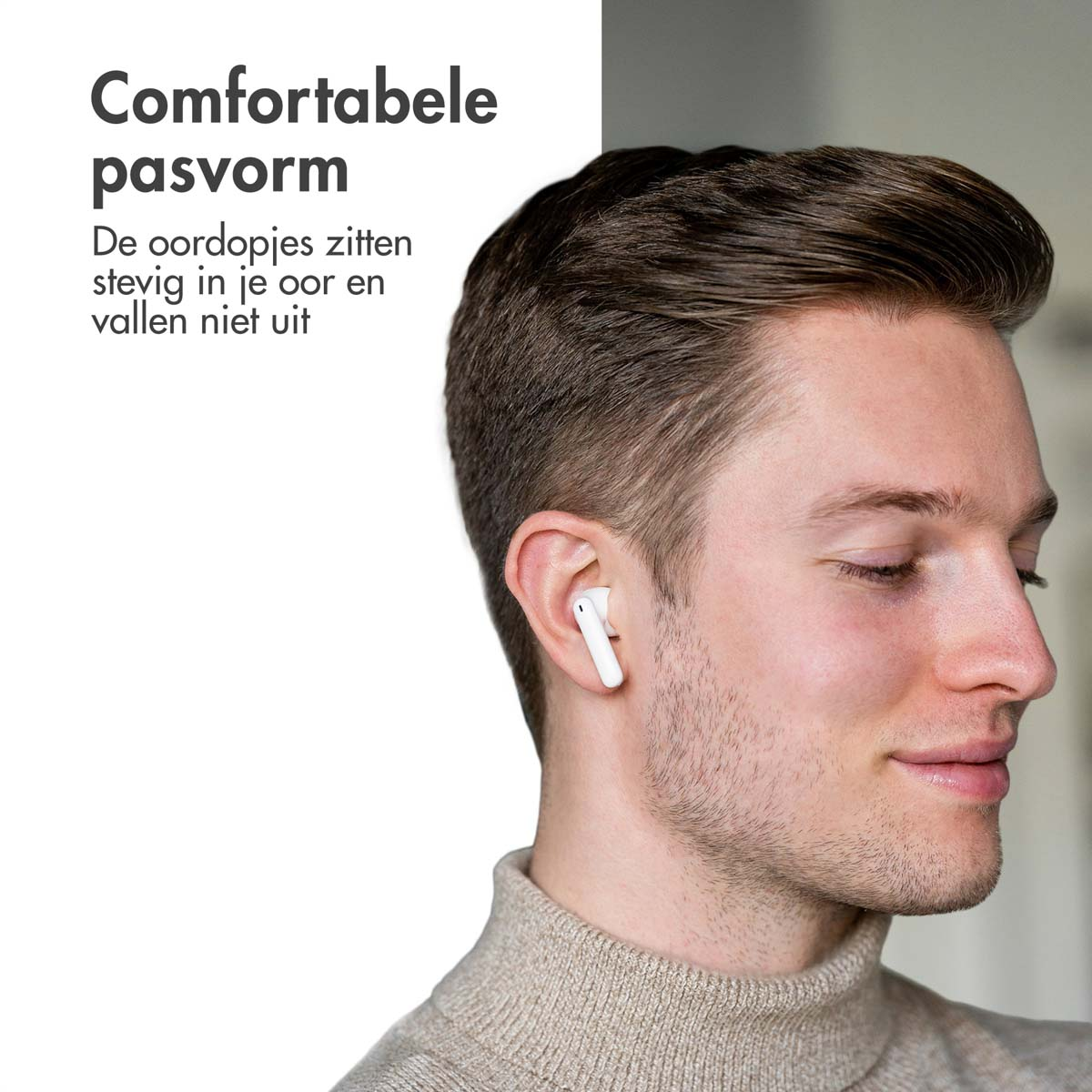 A man wearing white earbuds and a beige sweater. Text states comfortable fit.