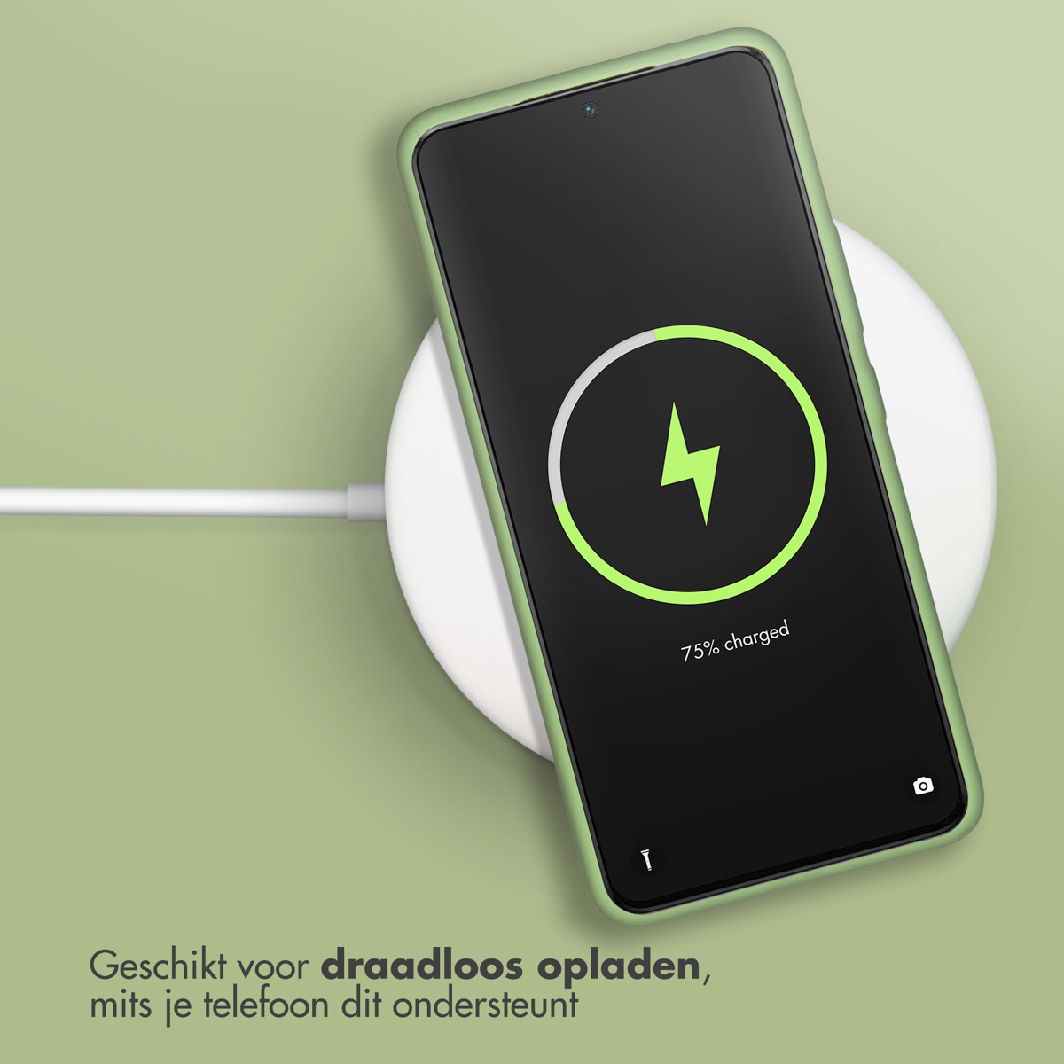 Phone on a wireless charger. Charger shows a charging symbol. Green background.