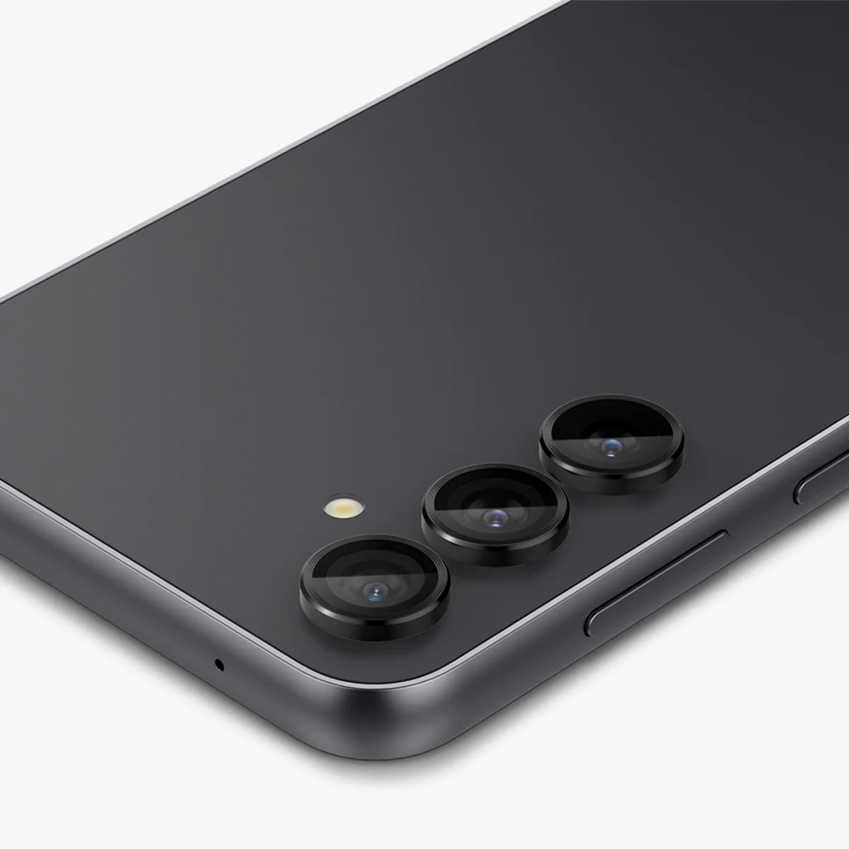 Gros plan sur l'arrière d'un téléphone avec trois objectifs photo. Objectifs noirs, dos gris.