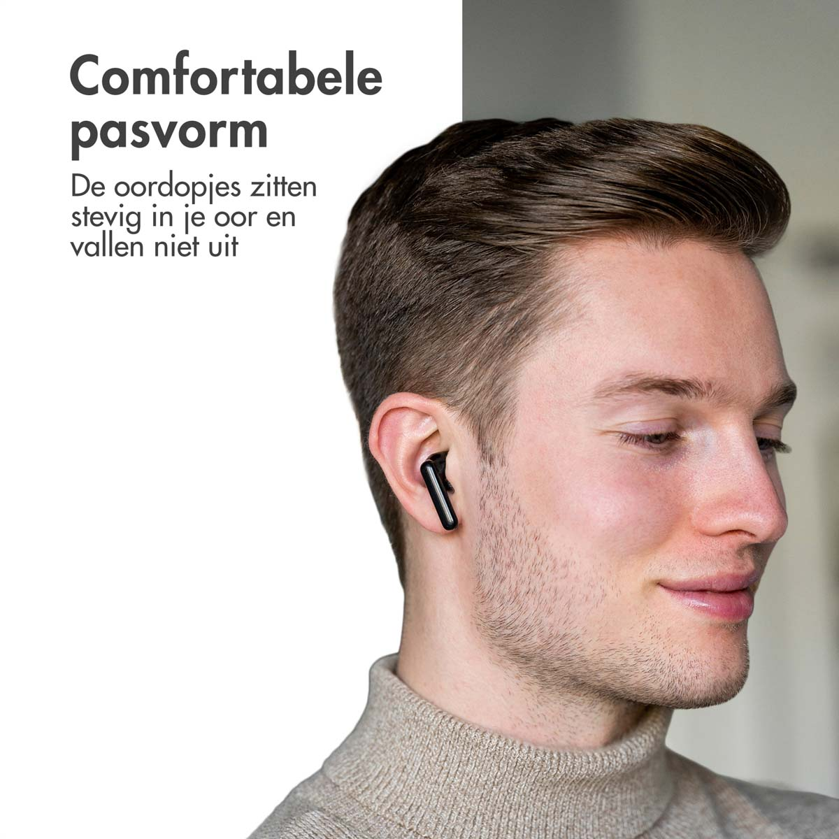 Man wearing a black earbud. Text says, comfortable fit. Earbud is in the ear.
