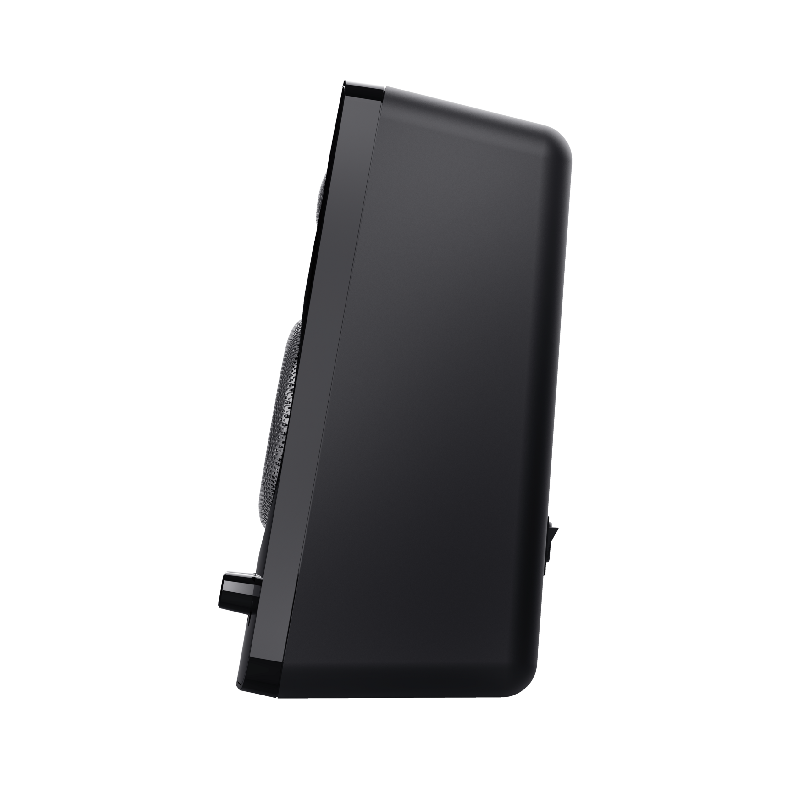 Czarny głośnik, widok z boku, na czarnej powierzchni. Ma siatkowy przód.