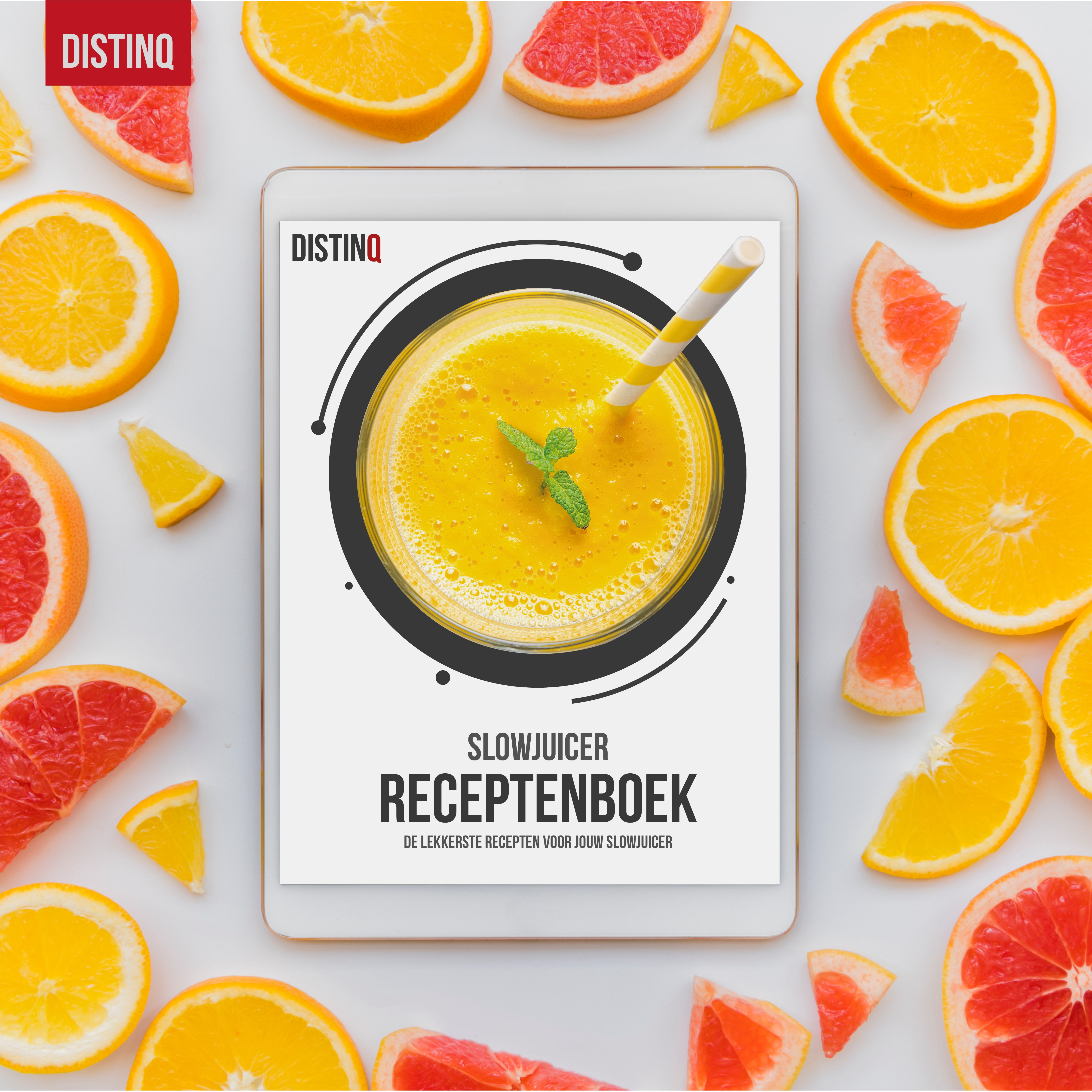 A tablet with a recipe book and oranges. The book is for a slow juicer and has a yellow smoothie.