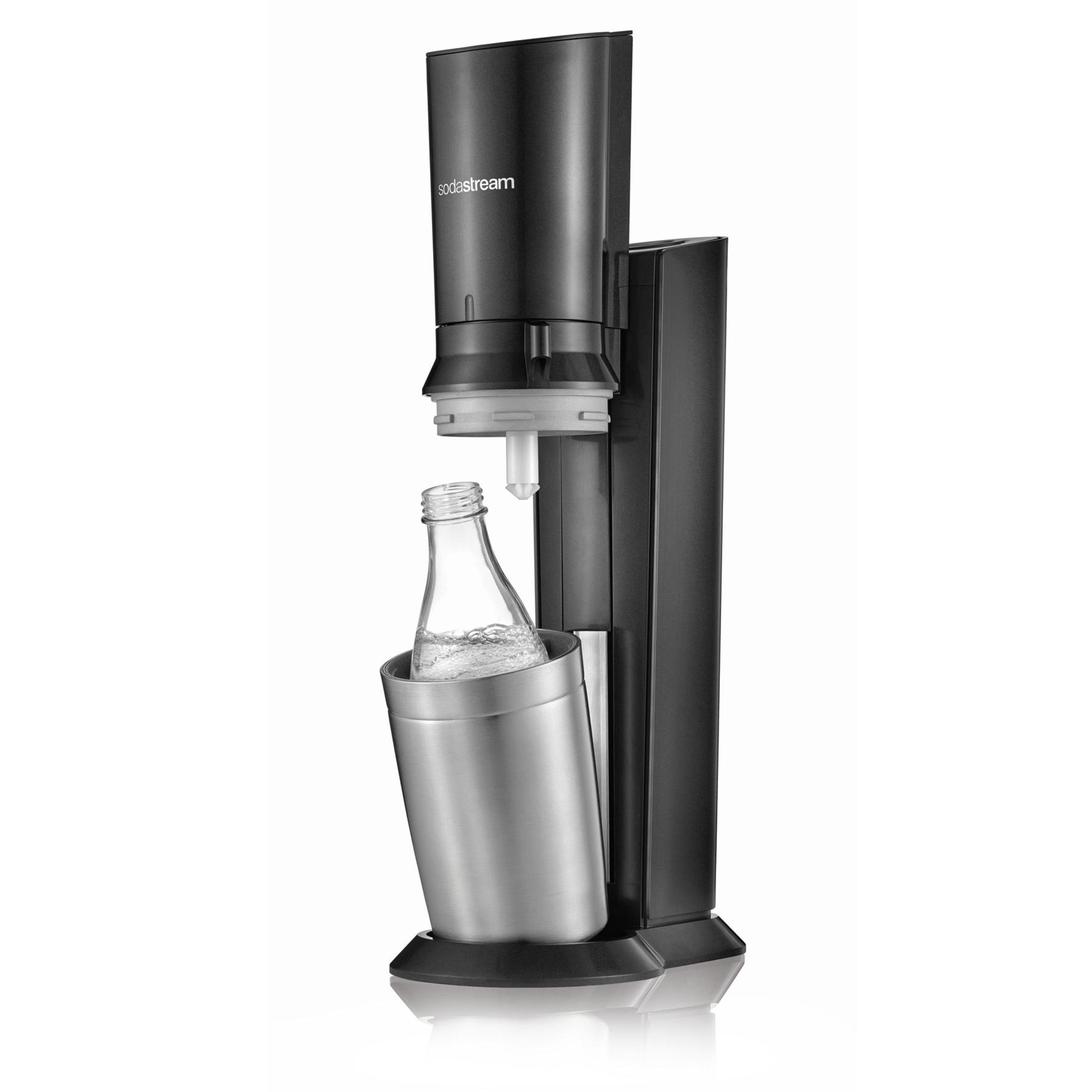 Black sodastream machine with a glass bottle inside, isolated on white background.