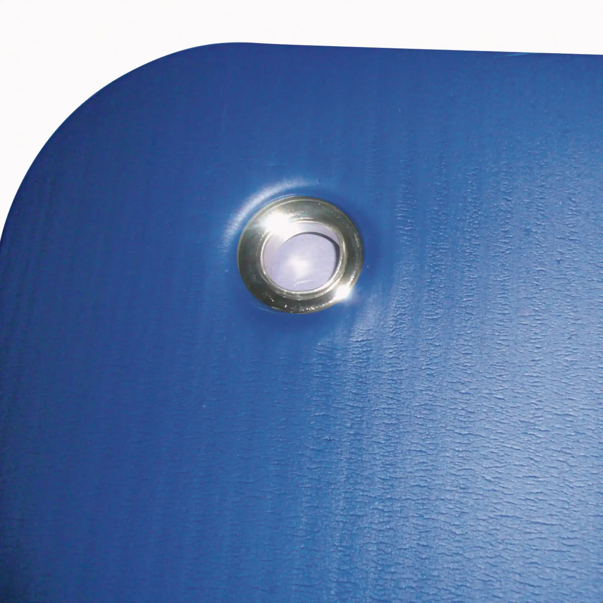 Blue surface with a metal ring. Shows the texture and the metal ring on the surface.