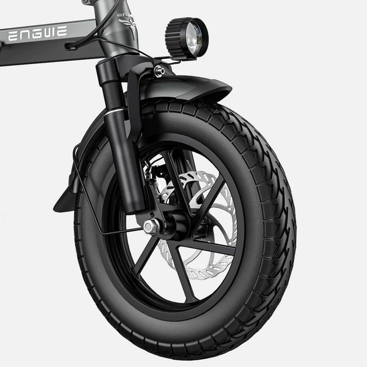Ruota di bici elettrica nera. Pneumatico, parafango e freno a disco neri. Disco e raggi argentati. Telaio grigio.