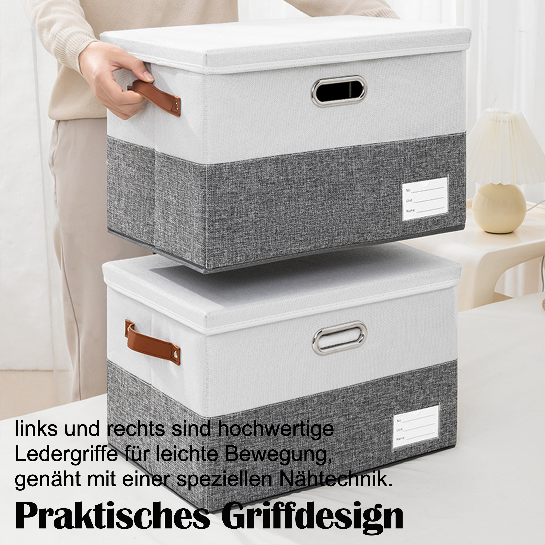 Zwei Stoff-Aufbewahrungsboxen, grau und weiß, mit Ledergriffen. Text auf Deutsch.
