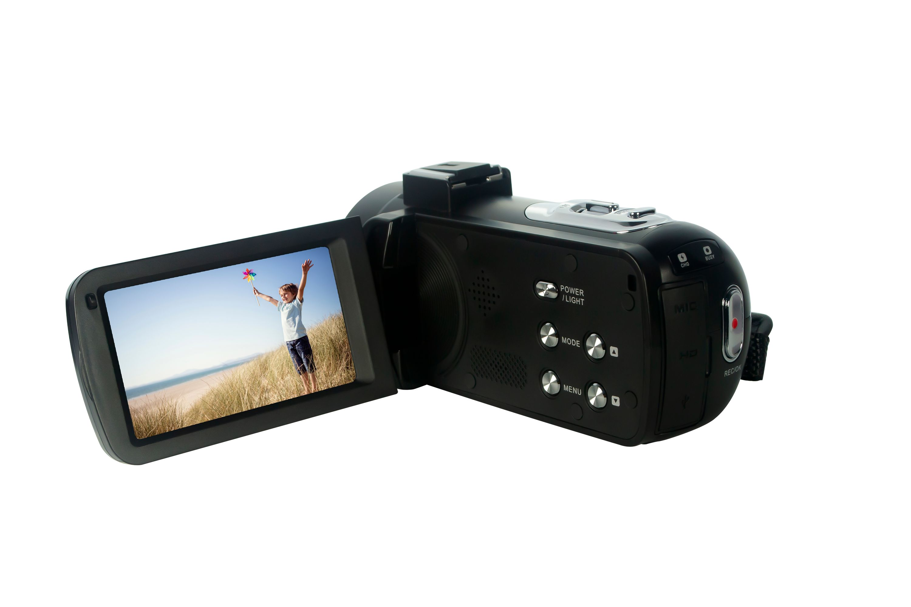 Czarna kamera z otwartym ekranem, pokazująca dziecko z zabawką na plaży. Białe tło.