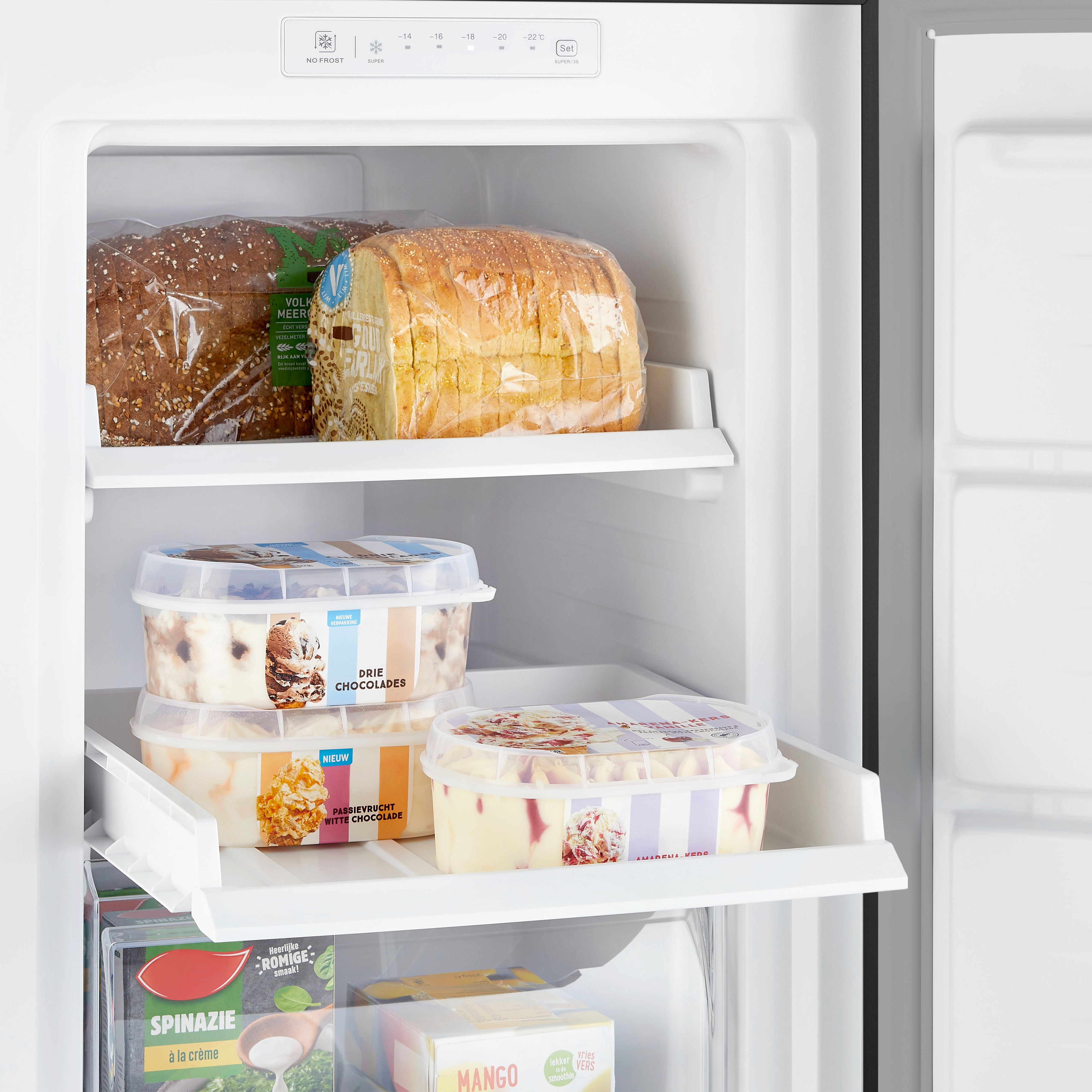 Refrigerator interior with bread and ice cream. Shelves visible with various food items.