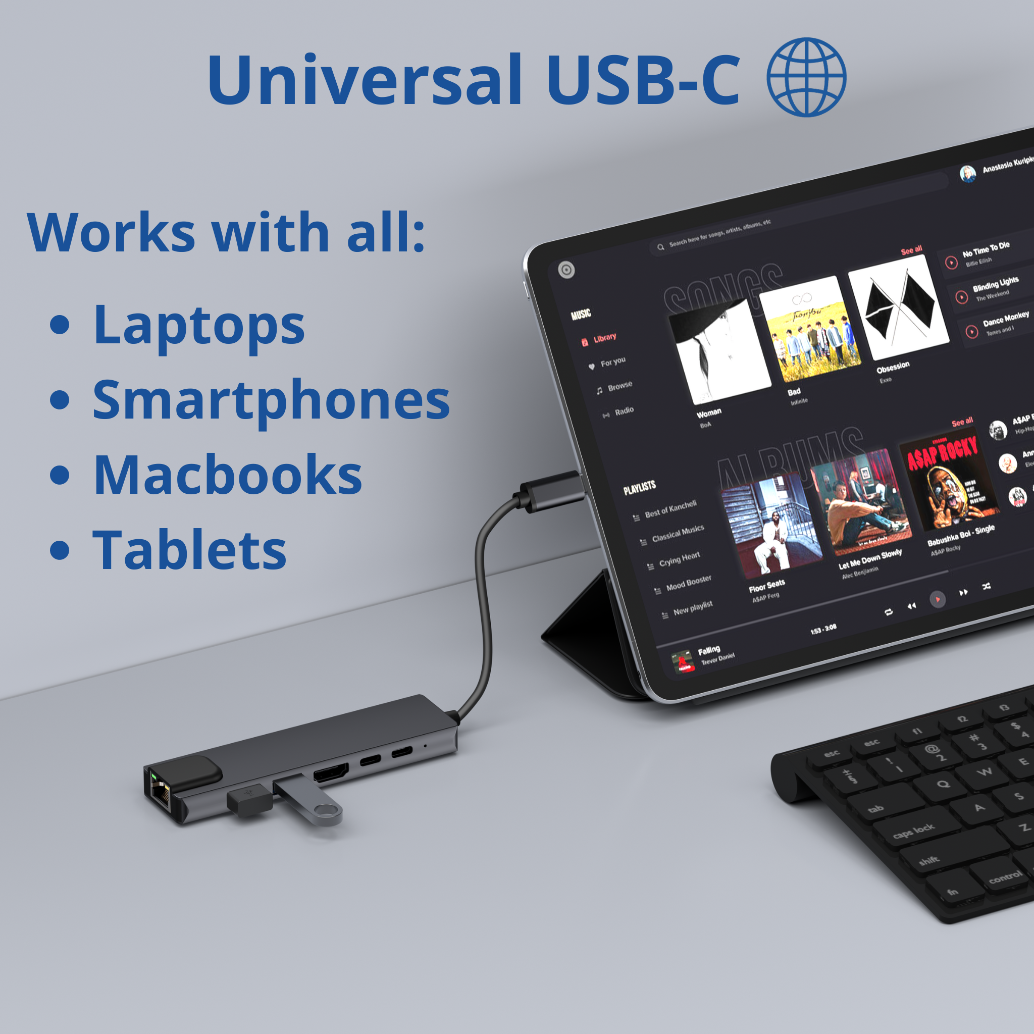 Un hub noir avec plusieurs ports connecté à une tablette et un clavier.