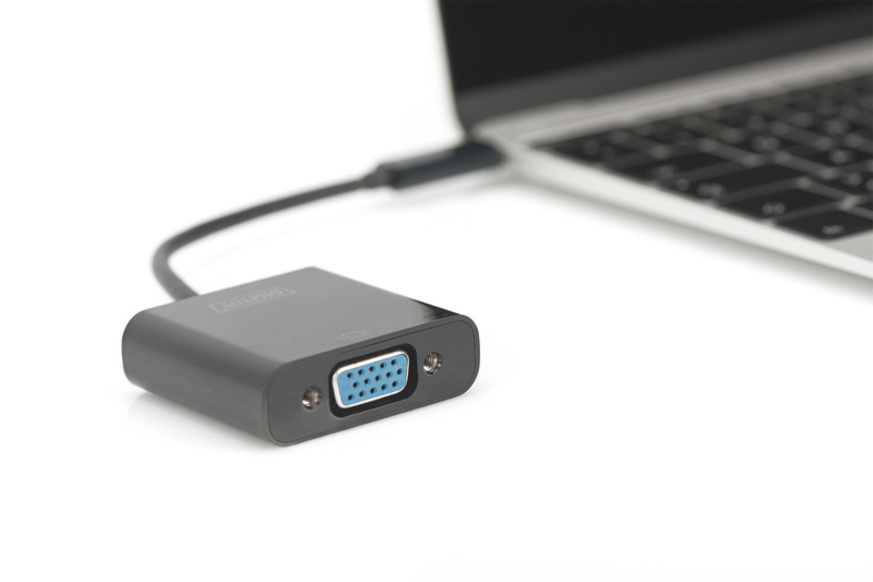 Ein grauer VGA-Adapter, der an einen Laptop angeschlossen ist. Der Adapter hat einen blauen VGA-Anschluss.