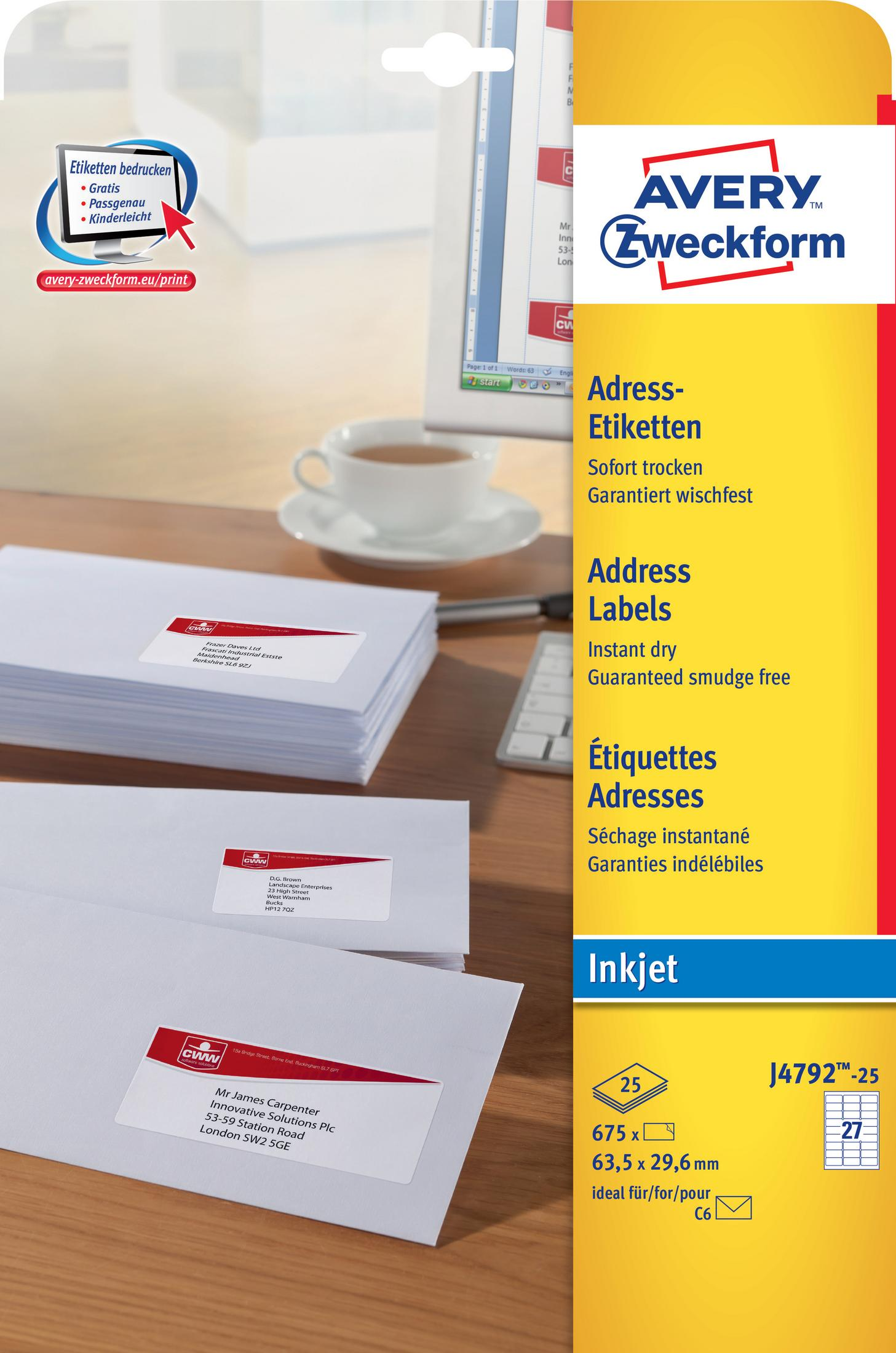 Stapel Adressetiketten-Umschläge und ein Computerbildschirm mit Tasse.