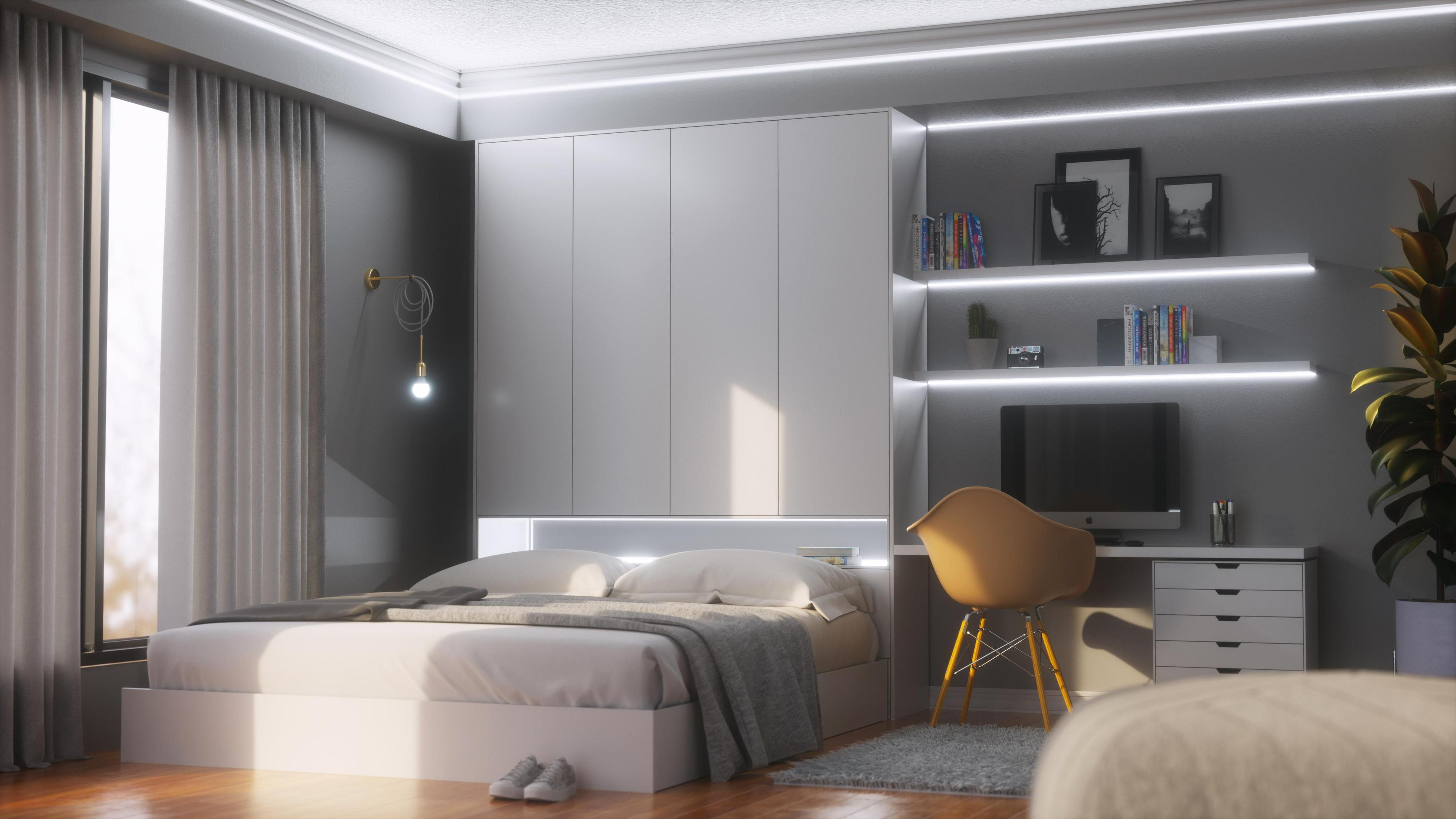 Schlafzimmer mit Bett, Schreibtisch und Schränken. Tageslicht.