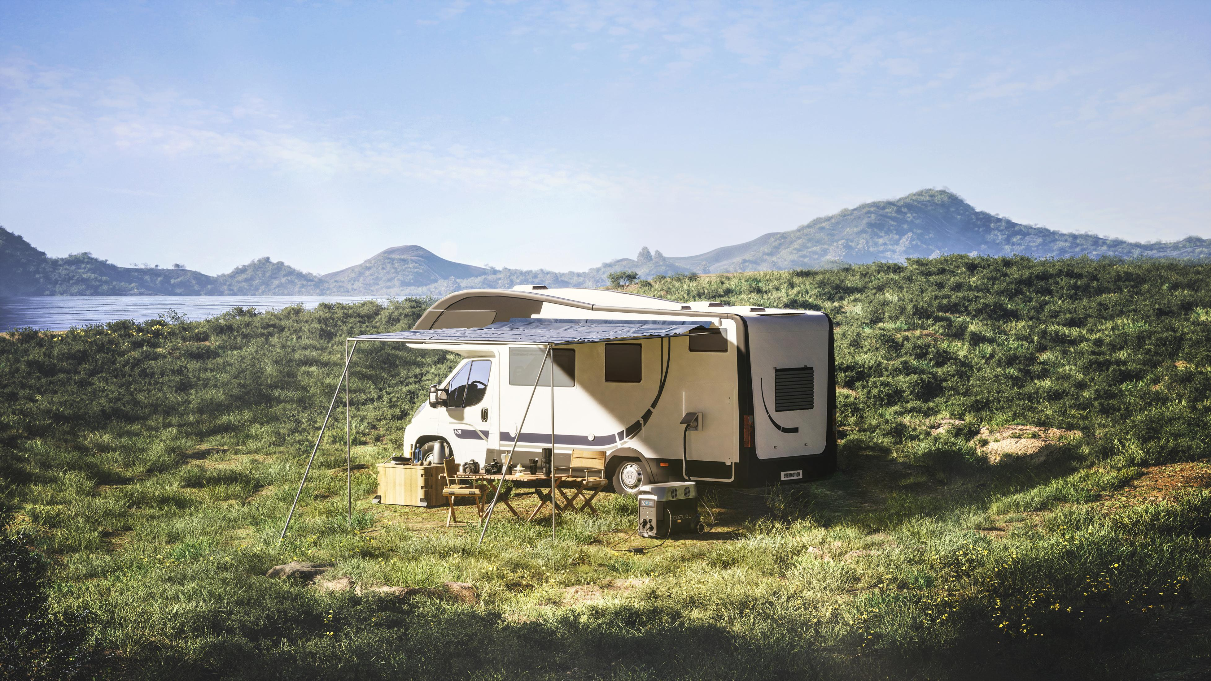 Camper parcheggiato in un campo erboso con montagne e lago in lontananza.