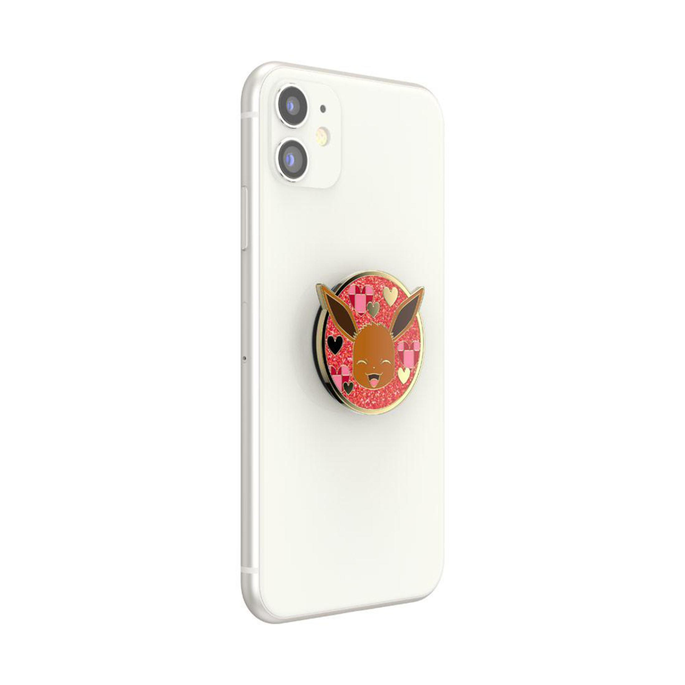 Ein weißes Telefon mit einem Eevee PopSocket angebracht.